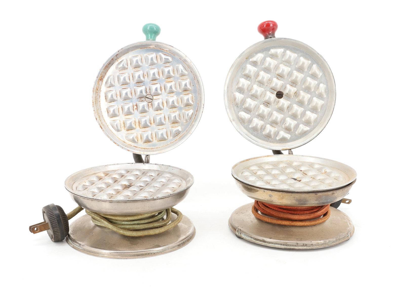 (2) VINTAGE, SMALL SIZE WAFFLE IRONS: ELECTRIC WAFFLE IRONS, CHROME AND ALUMINUM WITH RED AND GREEN PAINTED KNOBS, ORIGINAL POWER CORDS - 4 3/4" D PLEASE READ CAREFULLY - ITEMS MUST BE PAID FOR THROUGH LIVE AUCTIONEERS OR WITH CASH OR CHE
