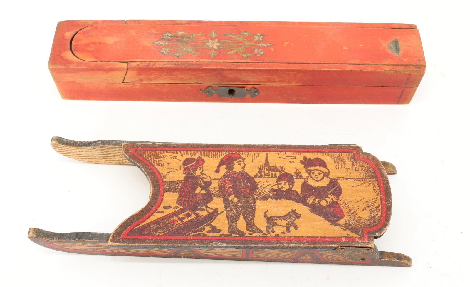 TOY SLED AND PENCIL BOX: WOODEN SLED WITH HINGED LID, DEPICTING CHILDREN SLEDDING ON TOP (8 1/2" L) - RED PAINTED SLIDE LID PENCIL BOX (9") WITH PIVOTING LID PLEASE READ CAREFULLY - ITEMS MUST BE PAID FOR THROUGH LIVE AUCTION