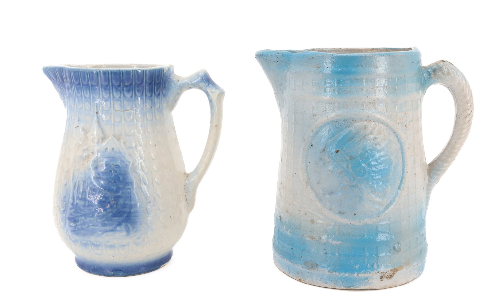 (2) BLUE AND WHITE SALT GLAZED PITCHER: MOLDED PITCHER WITH EMBOSSED NATIVE AMERICAN HEADS ON SIDES - SMALLER EMBOSSED PITCHER WITH CASTLES (7 3/4" H) PLEASE READ CAREFULLY - ITEMS MUST BE PAID FOR THROUGH LIVE AUCTIONEERS OR WITH CASH OR C