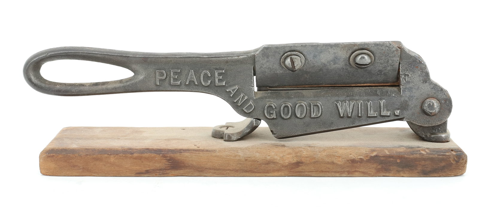 ANTIQUE CAST IRON TOBACCO CUTTER: MARKED; PEACE AND GOODWILL, MOUNTED ON WOODEN BASE - 10" L PLEASE READ CAREFULLY - ITEMS MUST BE PAID FOR THROUGH LIVE AUCTIONEERS OR WITH CASH OR CHECK IN PERSON - Terms for Purchasing and Shipping o