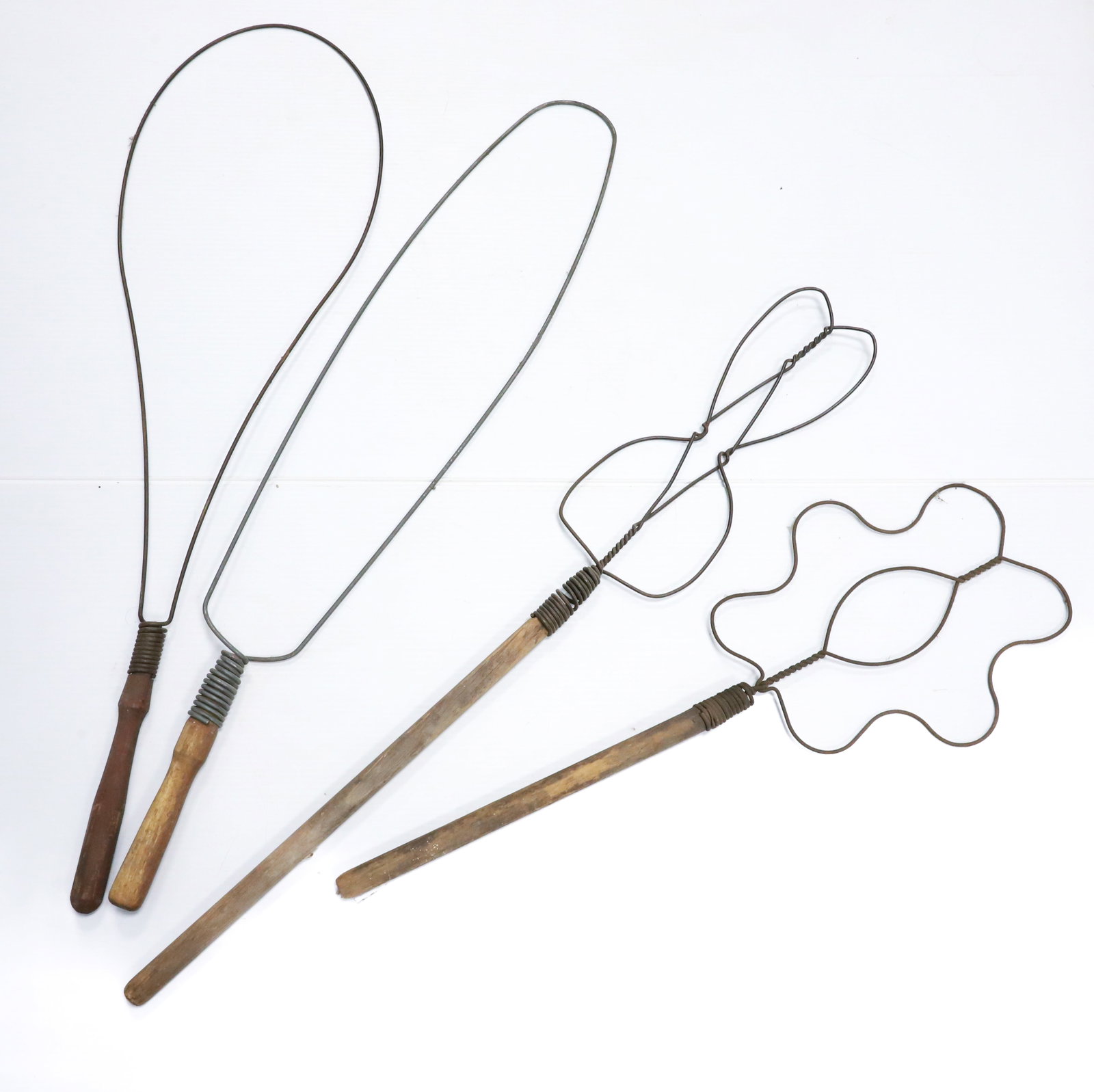 LOT OF (4) ANTIQUE RUG BEATERS: BENT WIRE DESIGNS, COILED WIRE AT TOP OF WOODEN HANDLES - 27 1/2" TO 34 1/2" L PLEASE READ CAREFULLY - ITEMS MUST BE PAID FOR THROUGH LIVE AUCTIONEERS OR WITH CASH OR CHECK IN PERSON - Terms for