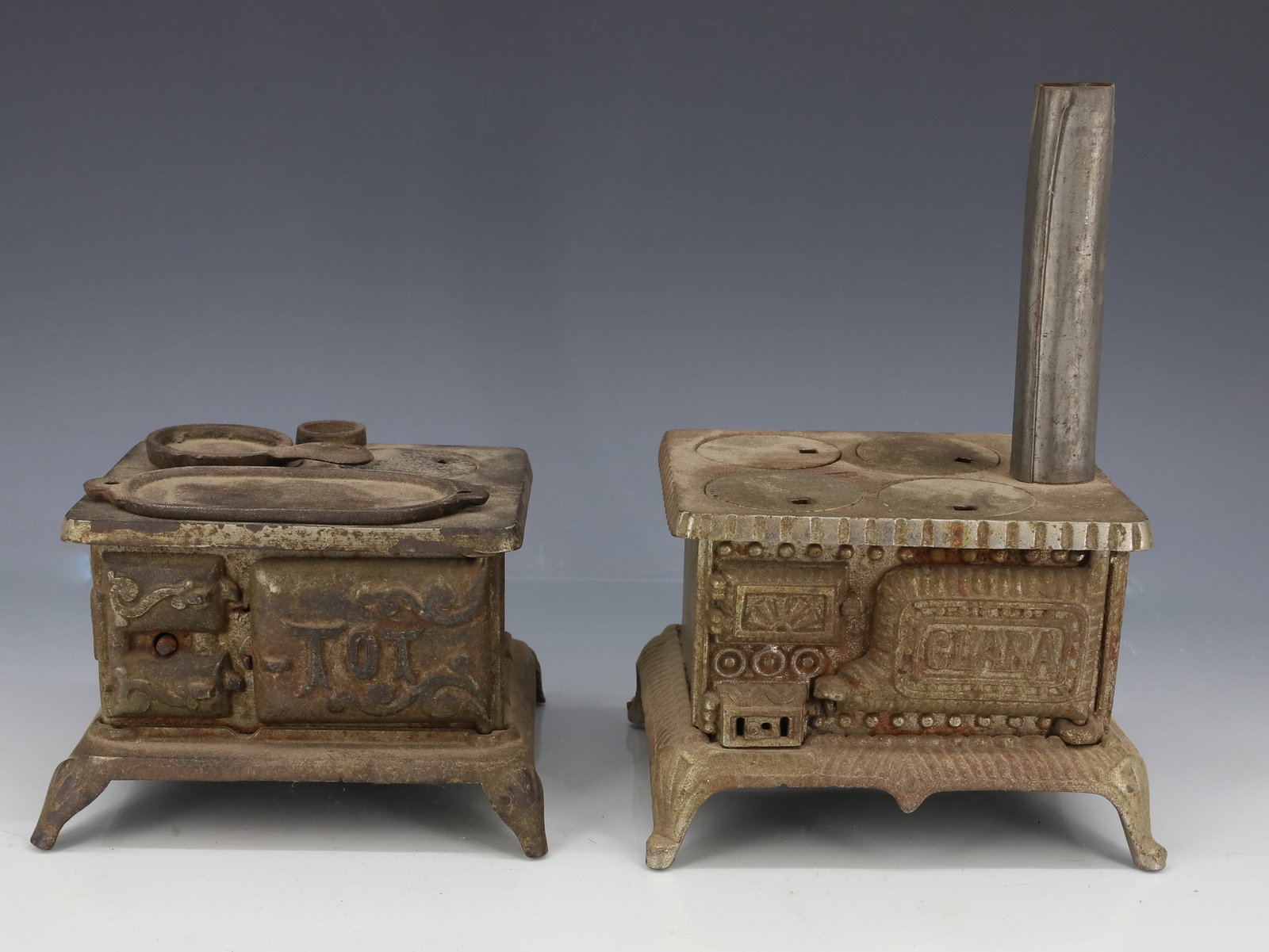 (2) MINIATURE CAST IRON STOVES: ONE MARKED; TOT OTHER MARKED; CLARA - 3 1/4" X 5 1/4" X 4 3/4" - 3 1/2" X 5 1/4" X 4 1/4" PLEASE READ CAREFULLY - ITEMS MUST BE PAID FOR THROUGH LIVE AUCTIONEERS OR WITH CASH OR CHECK IN PERSON - Term