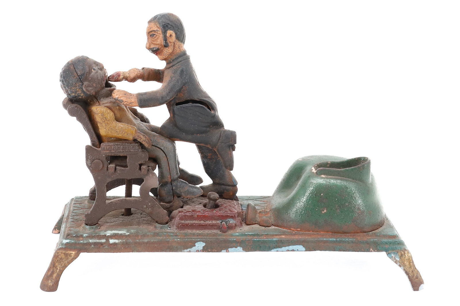CAST IRON "DENTIST" MECHANICAL BANK: PAINTED SURFACE WITH PATIENT IN CHAIR AND DENTIST PULLING TOOTH. UNMARKED. WORKING ORDER. 9 1/4" L. PLEASE READ CAREFULLY - ITEMS MUST BE PAID FOR THROUGH LIVE AUCTIONEERS OR WITH CASH OR CHECK IN PER