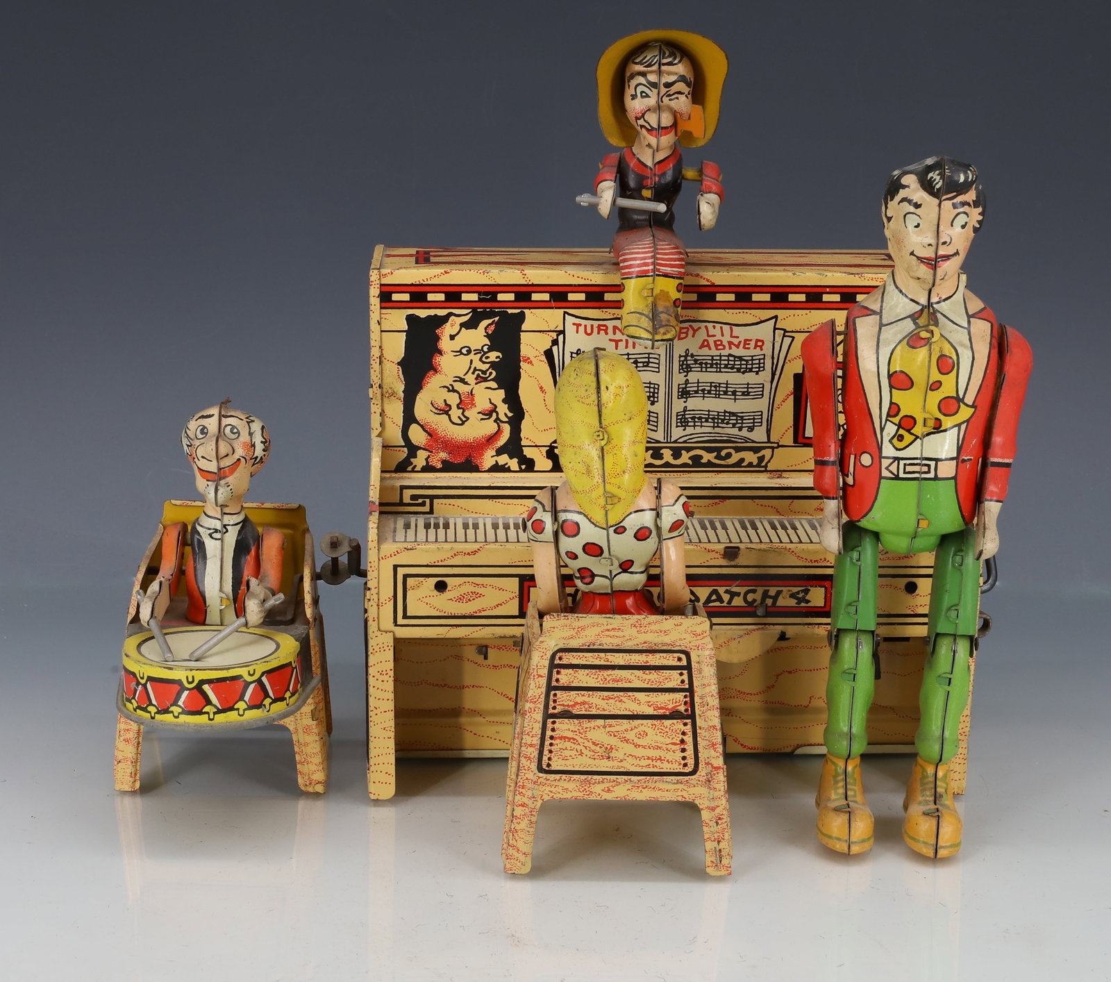 TIN LITHO "LIL ABNER DOGPATCH BAND" TOY: MRKD. "UNIQUE ART MANUFACTURING CO., COPR. 1945..." 8 1/4" X 9". PLEASE READ CAREFULLY - ITEMS MUST BE PAID FOR THROUGH LIVE AUCTIONEERS OR WITH CASH OR CHECK IN PERSON - Terms for Purchasing and Ship