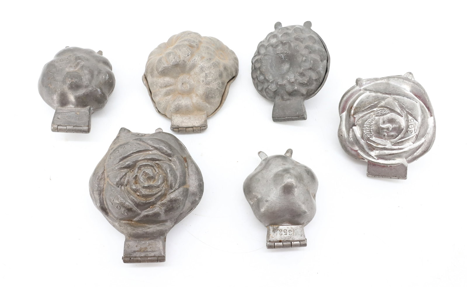 LOT OF (6) ICE CREAM MOLDS: VARIOUS FLOWERS. LARGEST MRKD. E&CO.295. CUPID IN ROSE (306). SEVERAL MRKD. E&CO. NY. PLEASE READ CAREFULLY - ITEMS MUST BE PAID FOR THROUGH LIVE AUCTIONEERS OR WITH CASH OR CHECK IN PERSON - Terms fo