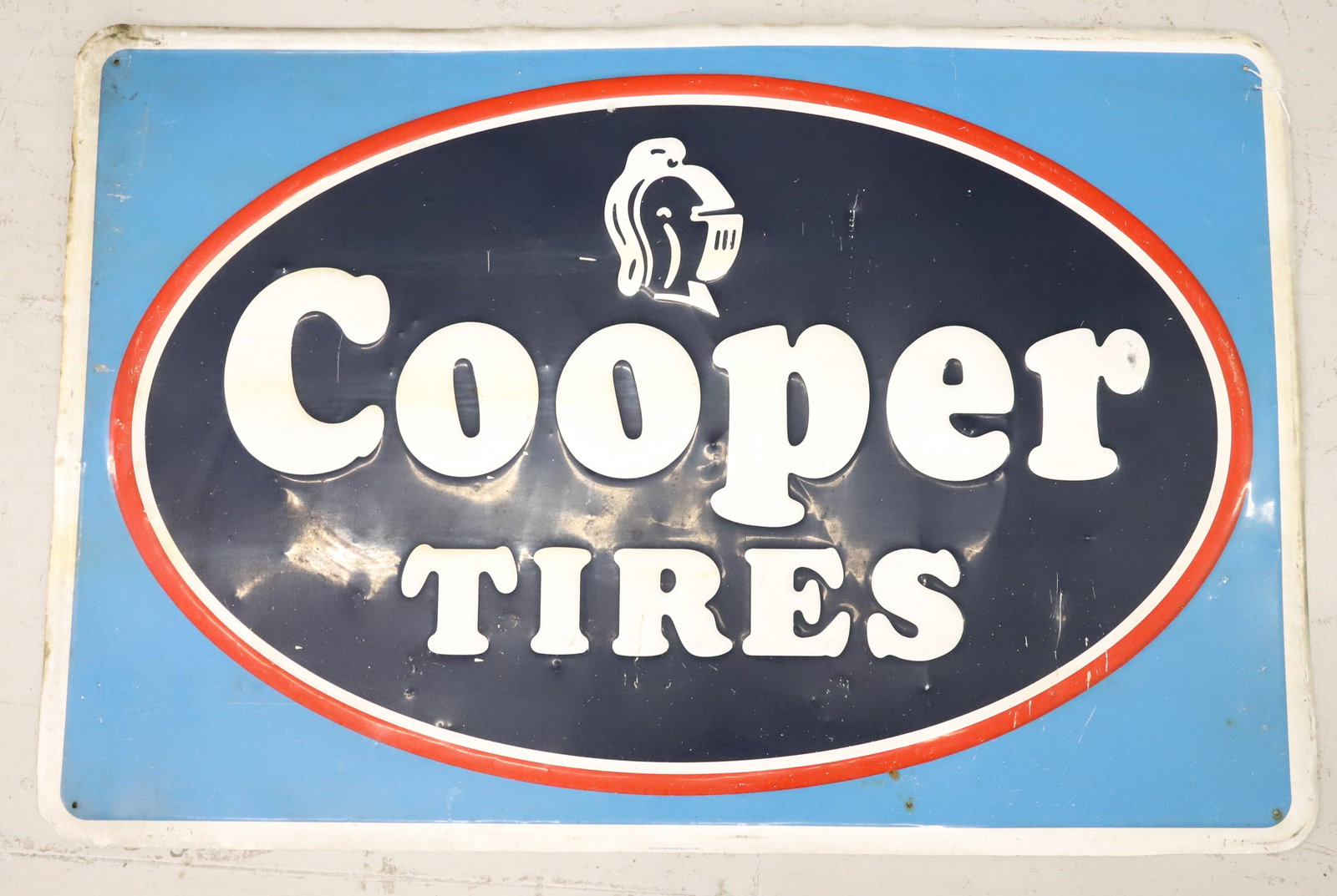 "COOPER TIRES" PRESSED METAL ADVERTISING SIGN: EMBOSSED SIGN IN RED / WHITE / BLUE. 30" X 45". PLEASE READ CAREFULLY - ITEMS MUST BE PAID FOR THROUGH LIVE AUCTIONEERS OR WITH CASH OR CHECK IN PERSON - Terms for Purchasing and Shipping of Auction I