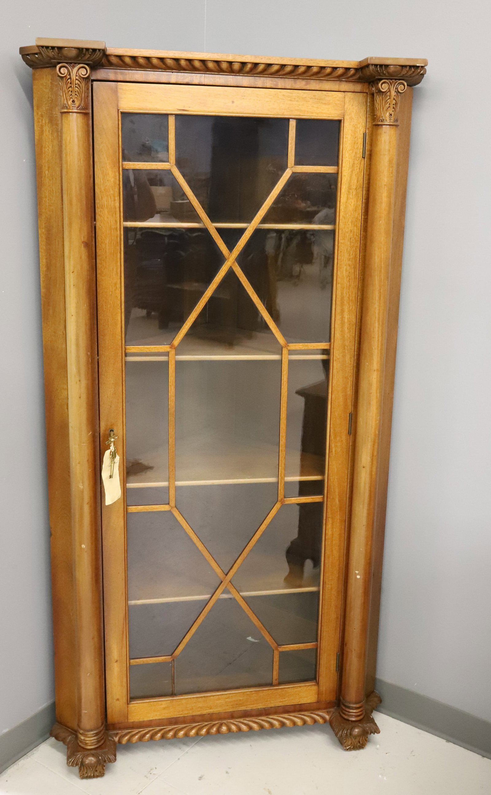 MAHOGANY CORNER CABINET: 1920C CORNER CABINET WITH COLUMNS, PAW FEET AND FRETWORK GLASS DOOR, THREE SHELVES REFINISHED LOCK WITH KEYS 64" X 34" X 20" PLEASE READ CAREFULLY - ITEMS MUST BE PAID FOR THROUGH LIVE AUCTIONEERS OR