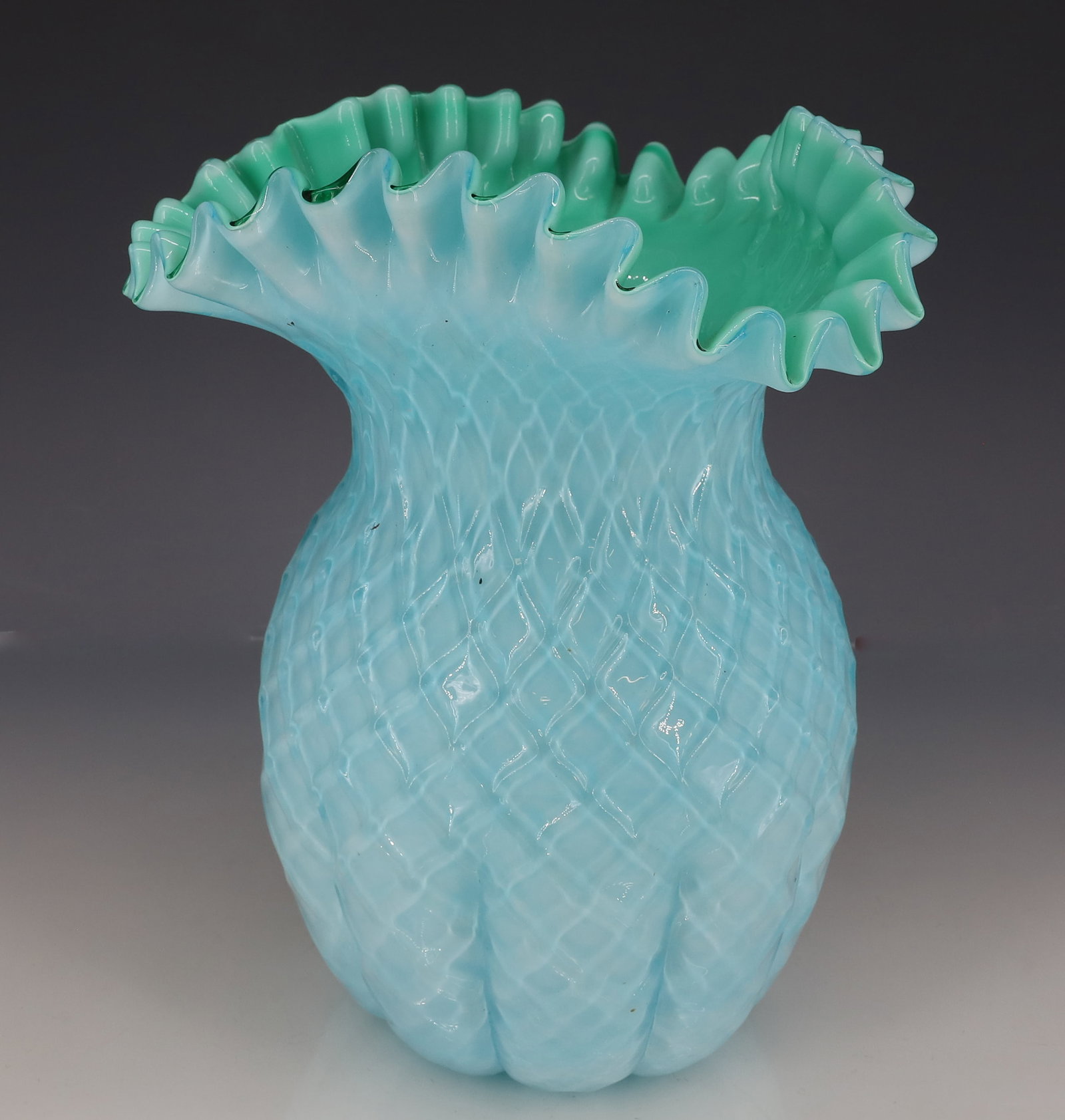 VICTORIAN ART GLASS RUFFLED VASE: CASED VASE WITH RUFFLED TOP AND QUILTED BODY. SMOOTH PONTIL. 9" H. PLEASE READ CAREFULLY - ITEMS MUST BE PAID FOR THROUGH LIVE AUCTIONEERS OR WITH CASH OR CHECK IN PERSON - Terms for Purchasing and Sh