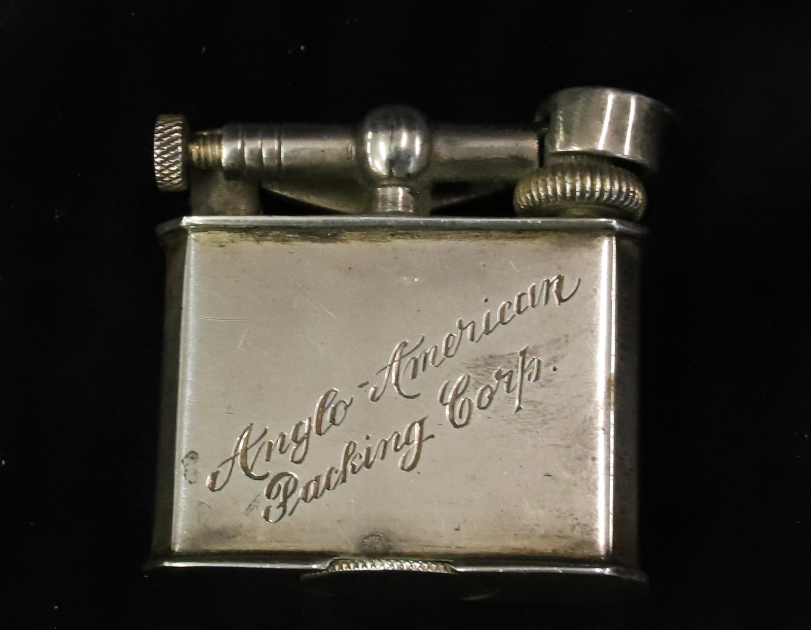 MEXICO STERLING SILVER LIGHTER: LIFT ARM LIGHTER FOR "ANGLO-AMERICAN PACKING CORP" STERLING SILVER MEXICO WEIGHT 2. OZT 1 1/2" X 1 3/4" PLEASE READ CAREFULLY - ITEMS MUST BE PAID FOR THROUGH LIVE AUCTIONEERS OR WITH CASH OR CHECK