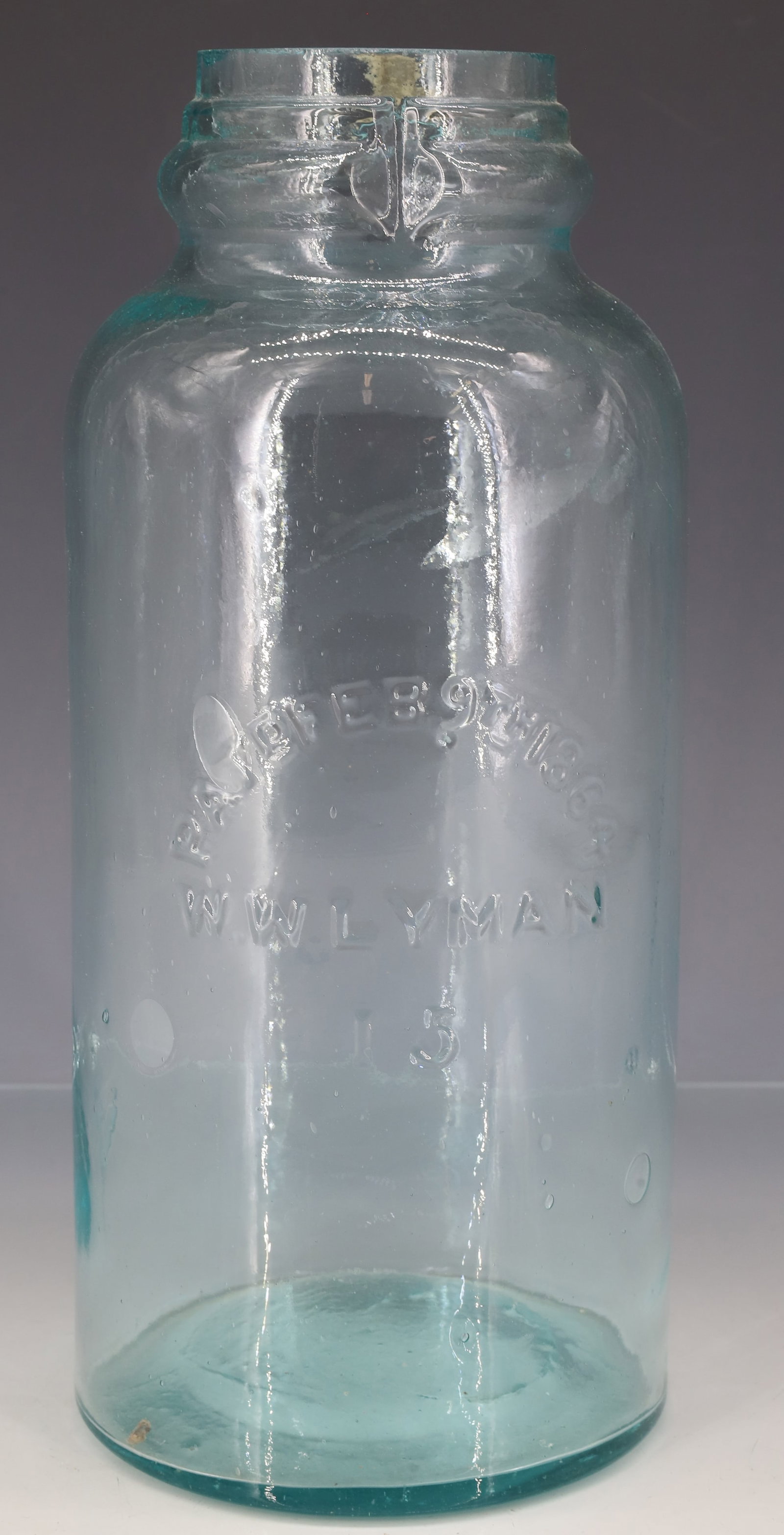 W.W. LYMAN FRUIT JAR: AQUA JAR EMBOSSED "PAT'D FEB 9TH 1864, W.W. LYMAN 15" 9 7/8" H. PLEASE READ CAREFULLY - ITEMS MUST BE PAID FOR THROUGH LIVE AUCTIONEERS OR WITH CASH OR CHECK IN PERSON - Terms for Purchasing and Shipp
