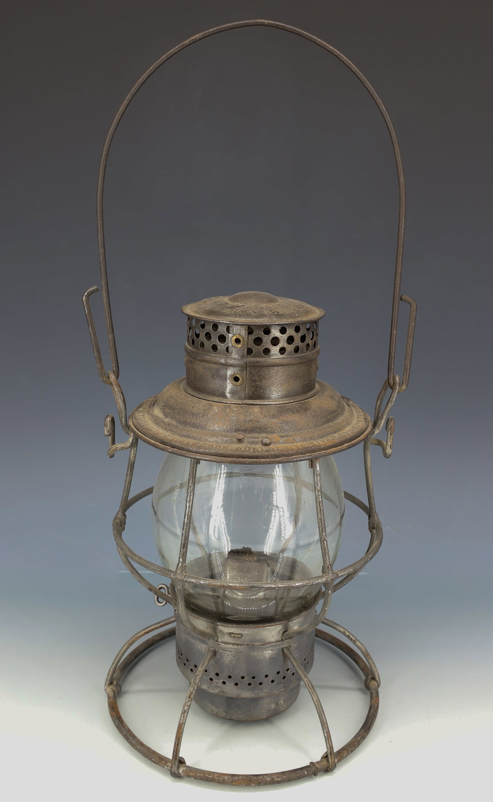 PENNSYLVANIA RAILROAD LANTERN: PRR. ADLAKE RELIABLE. EMBOSSED RAILROAD LOGO ON GLOBE. 10 1/4" H. PLEASE READ CAREFULLY - ITEMS MUST BE PAID FOR THROUGH LIVE AUCTIONEERS OR WITH CASH OR CHECK IN PERSON - Terms for Purchasing and