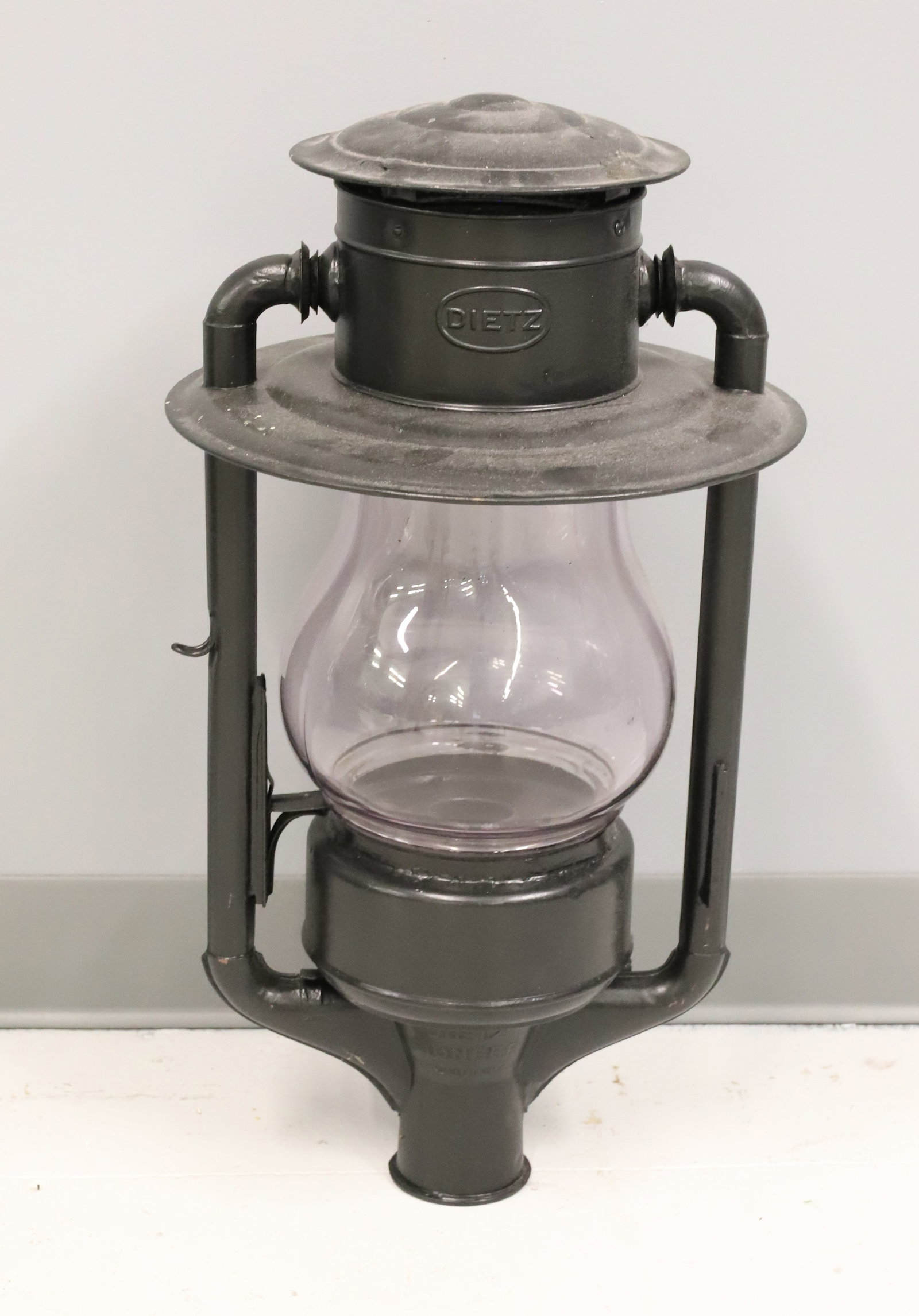 DIETZ PIONEER KEROSENE LAMP: BLACK PAINTED METAL WITH EMBOSSED GLOBE "DIETZ PIONEER". 24 1/2" H. PLEASE READ CAREFULLY - ITEMS MUST BE PAID FOR THROUGH LIVE AUCTIONEERS OR WITH CASH OR CHECK IN PERSON - Terms for Purchasing and