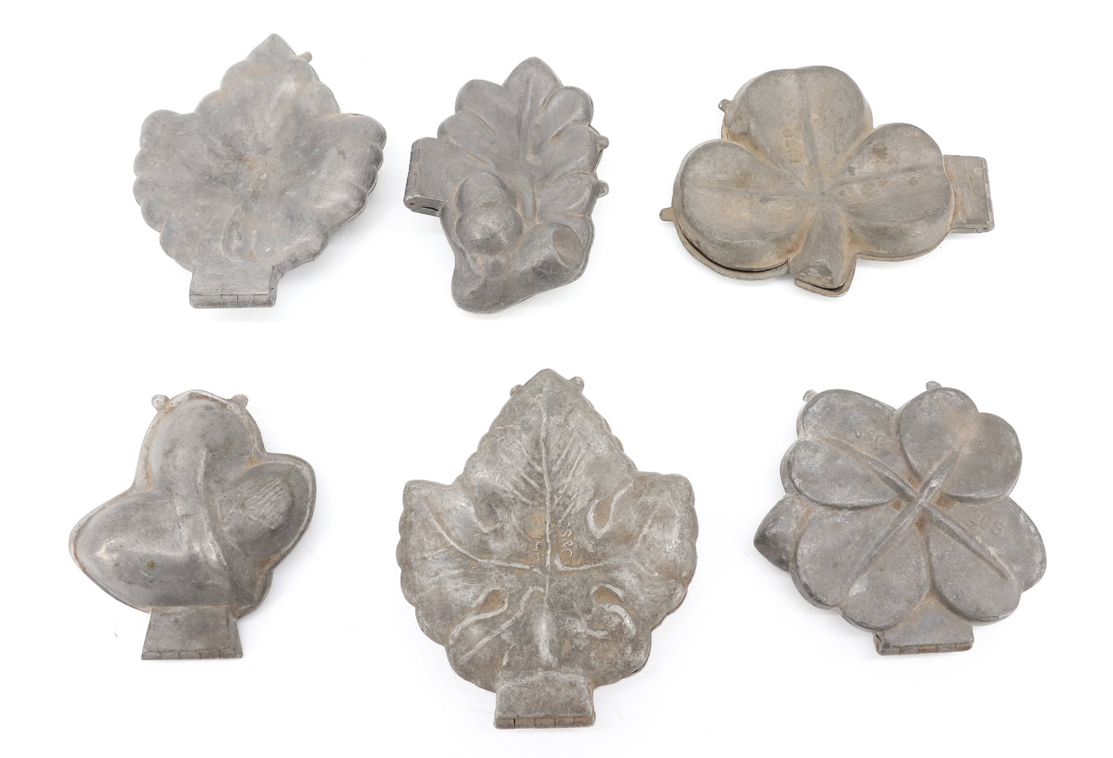 LOT OF (6) ICE CREAM MOLDS, CHOCOLATE: INCLUDING: VARIOUS TYPES OF LEAVES. INCLUDING: CLOVER (E&CO, NY 1028/1029). 4 1/8" X 5 1/4". OAK LEAF W/ ACORN ( S&CO. 385). (2) THREE-POINT LEAFS (S&CO AND E&CO N.Y.) AND MORE. PLEASE READ CAREFULLY 