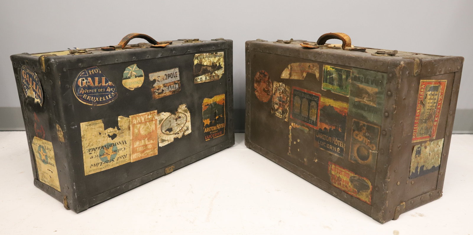 (2) ANTIQUE SUITCASES: TWO RECTANGULAR TRUNKS TRIMMED IN METAL WITH TRAVEL STICKERS. 9 1/2" X 23 3/4" X 15". PLEASE READ CAREFULLY - ITEMS MUST BE PAID FOR THROUGH LIVE AUCTIONEERS OR WITH CASH OR CHECK IN PERSON - Terms