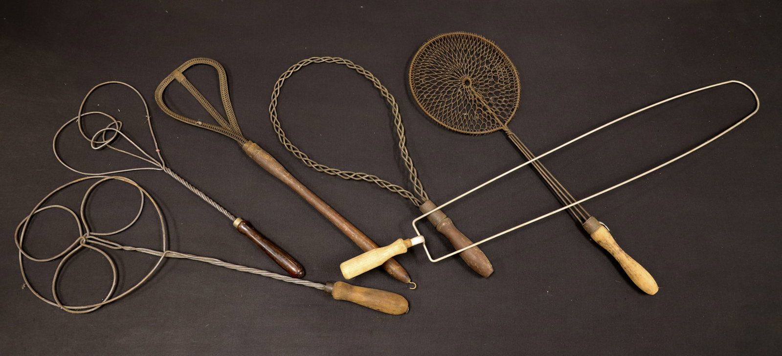 (6) ANTIQUE RUG BEATERS: VARIOUS SIZES AND FORMS WITH BENT WIRE AND WOODEN HANDLE GRIPS. LARGEST 35" L. PLEASE READ CAREFULLY - ITEMS MUST BE PAID FOR THROUGH LIVE AUCTIONEERS OR WITH CASH OR CHECK IN PERSON - Terms for Purch