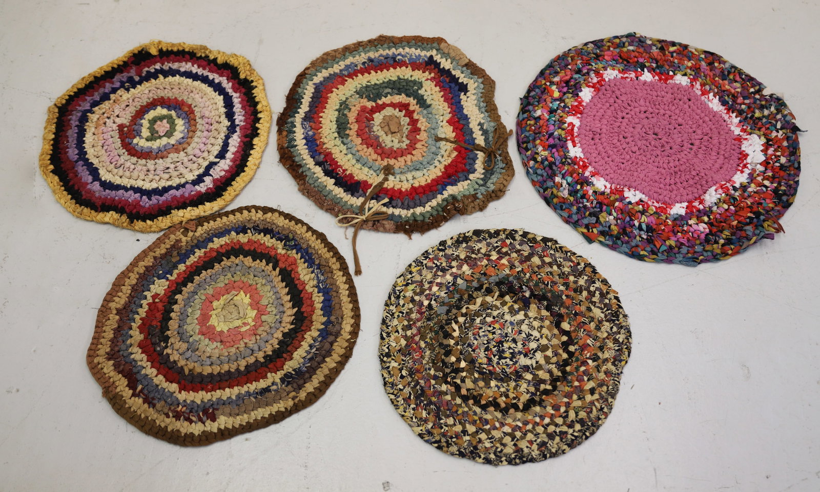 (5) HANDMADE THROW RUGS / TABLE MATS: VARIOUS SIZES AND COLORS. LARGEST 20" D. PLEASE READ CAREFULLY - ITEMS MUST BE PAID FOR THROUGH LIVE AUCTIONEERS OR WITH CASH OR CHECK IN PERSON - Terms for Purchasing and Shipping of Auction Items. P