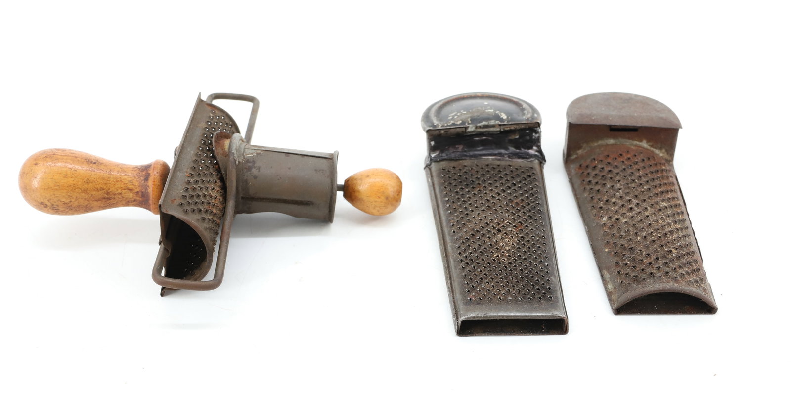 LOT OF (3) TIN NUTMEG GRATERS: INCLUDES: "THE EDGAR" PATENT 1896. TWO WOODEN KNOBS. 5 1/4" L. WITH TWO THAT HAVE HINGED LIDS AT ENDS. 4 7/8" AND 5 1/8" LENGTHS. PLEASE READ CAREFULLY - ITEMS MUST BE PAID FOR THROUGH LIVE AUCTIONEER