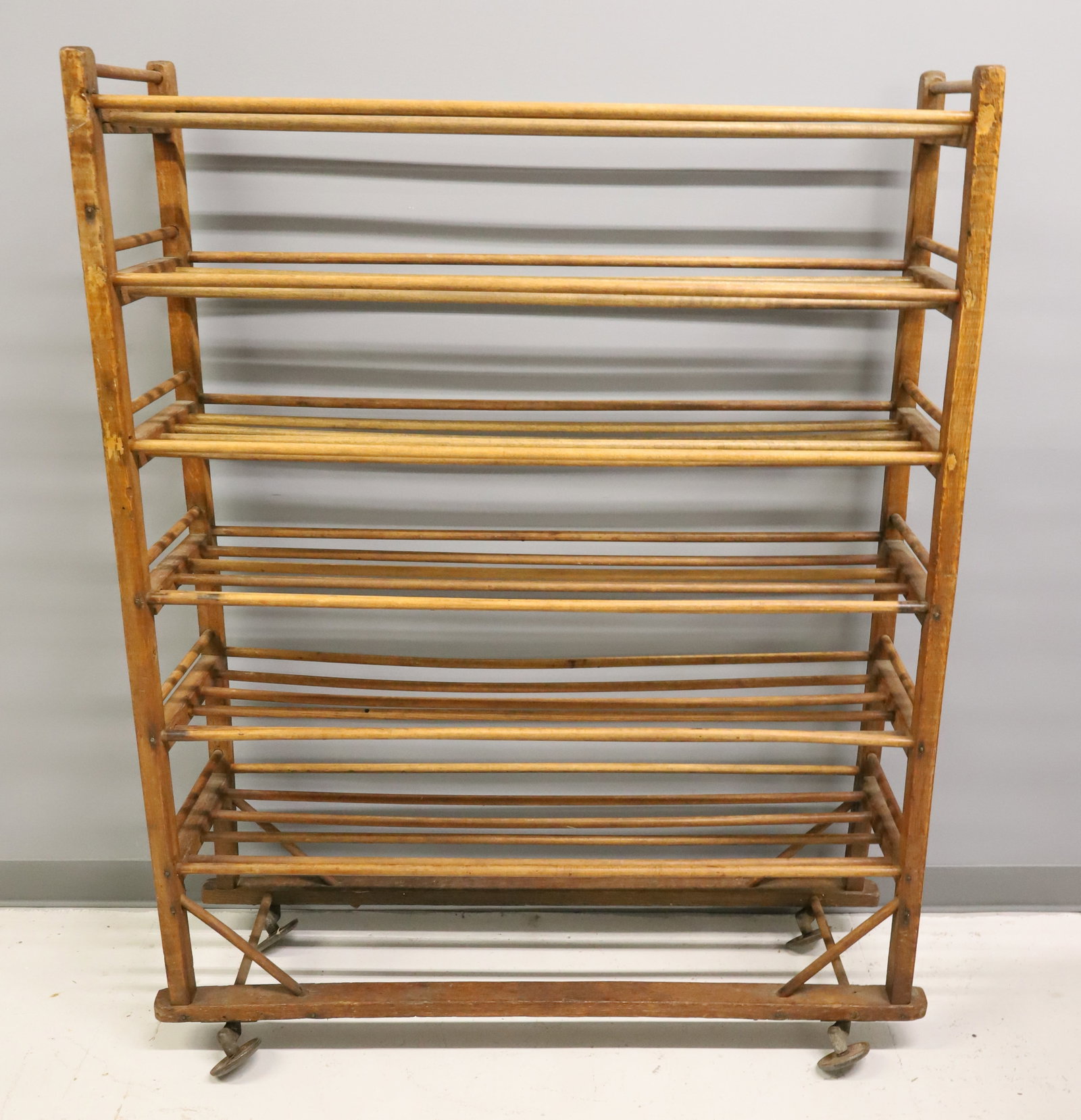 LARGE WOODEN FACTORY RACK: SIX WOODEN SPINDLE SHELVES. CASTERS ON BOTTOM. 55" X 42" X 12". PLEASE READ CAREFULLY - ITEMS MUST BE PAID FOR THROUGH LIVE AUCTIONEERS OR WITH CASH OR CHECK IN PERSON - Terms for Purchasing and Shipp
