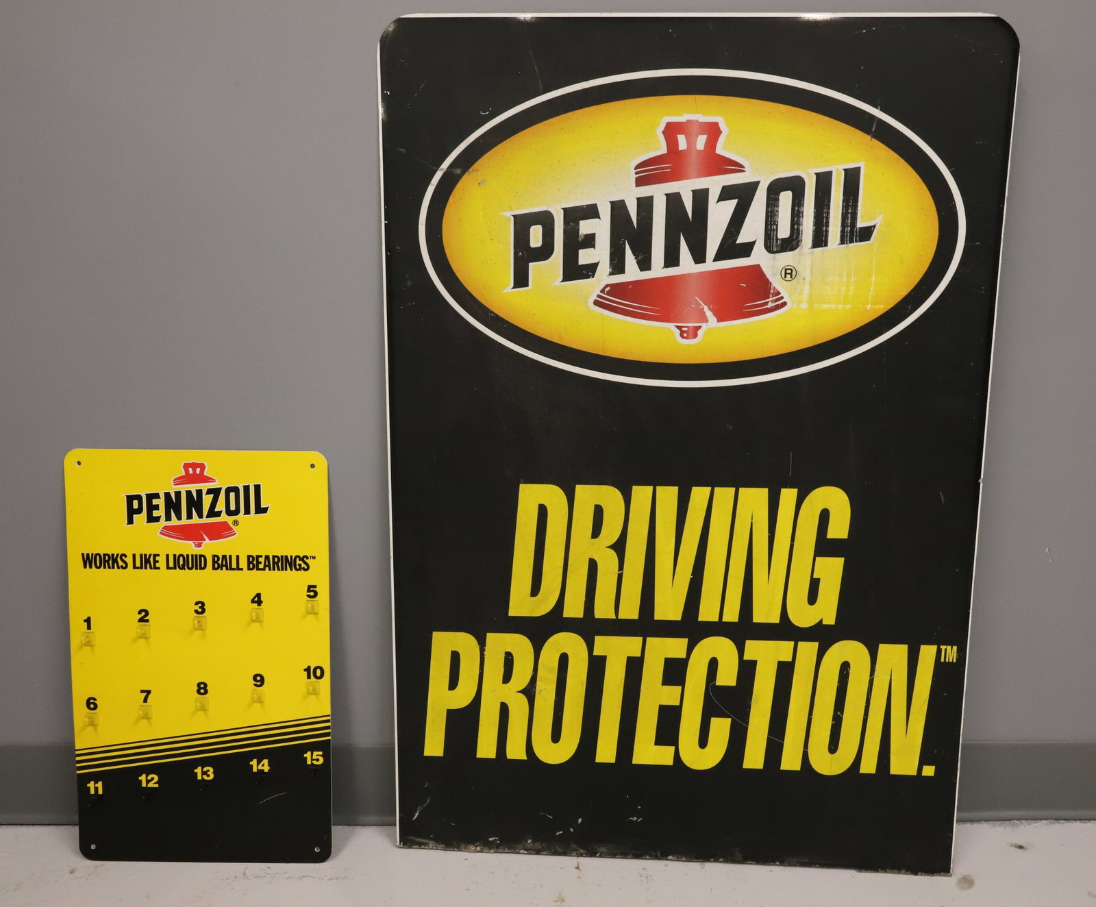 (2) PENNZOIL ADVERTISING SIGNS: DOUBLE-SIDED METAL SIGN 34 3/4" X 24". WITH, PLASTIC "LIQUID BALL BEARINGS" SIGN WITH PLASTIC HOOKS. PLEASE READ CAREFULLY - ITEMS MUST BE PAID FOR THROUGH LIVE AUCTIONEERS OR WITH CASH OR CHECK IN