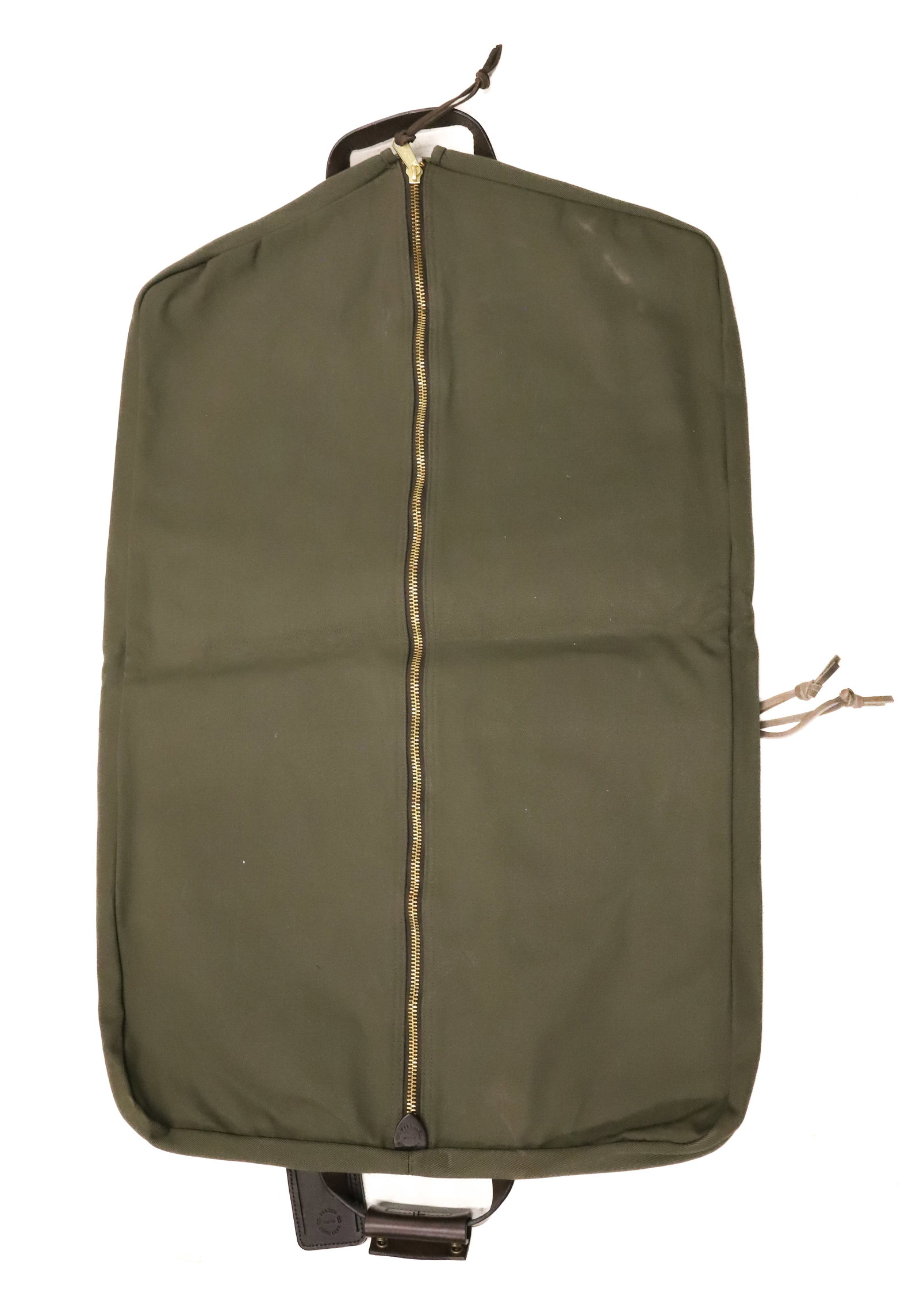 FILSON TWILL CANVAS GARMENT BAG: OTTER GREEN TWILL CANVAS. BRASS HARDWARE. LEATHER TRIM. 38" X 24 1/2" OPEN. PLEASE READ CAREFULLY - ITEMS MUST BE PAID FOR THROUGH LIVE AUCTIONEERS OR WITH CASH OR CHECK IN PERSON - Terms for