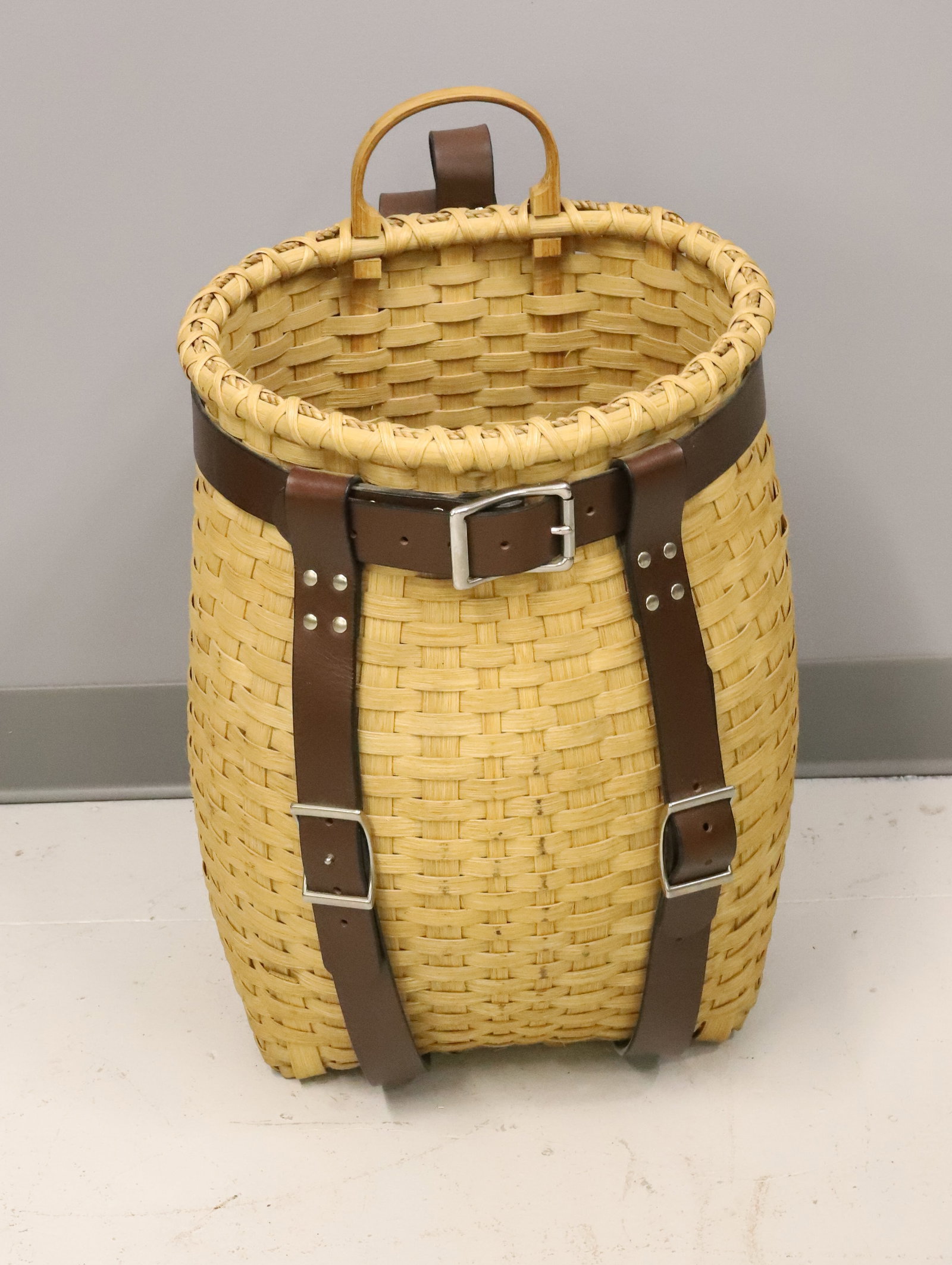 ADIRONDACK PACK BASKET: BENTWOOD HANDLE AND LEATHER HARNESS. 20" X 13" X 12" PLEASE READ CAREFULLY - ITEMS MUST BE PAID FOR THROUGH LIVE AUCTIONEERS OR WITH CASH OR CHECK IN PERSON - Terms for Purchasing and Shipping of