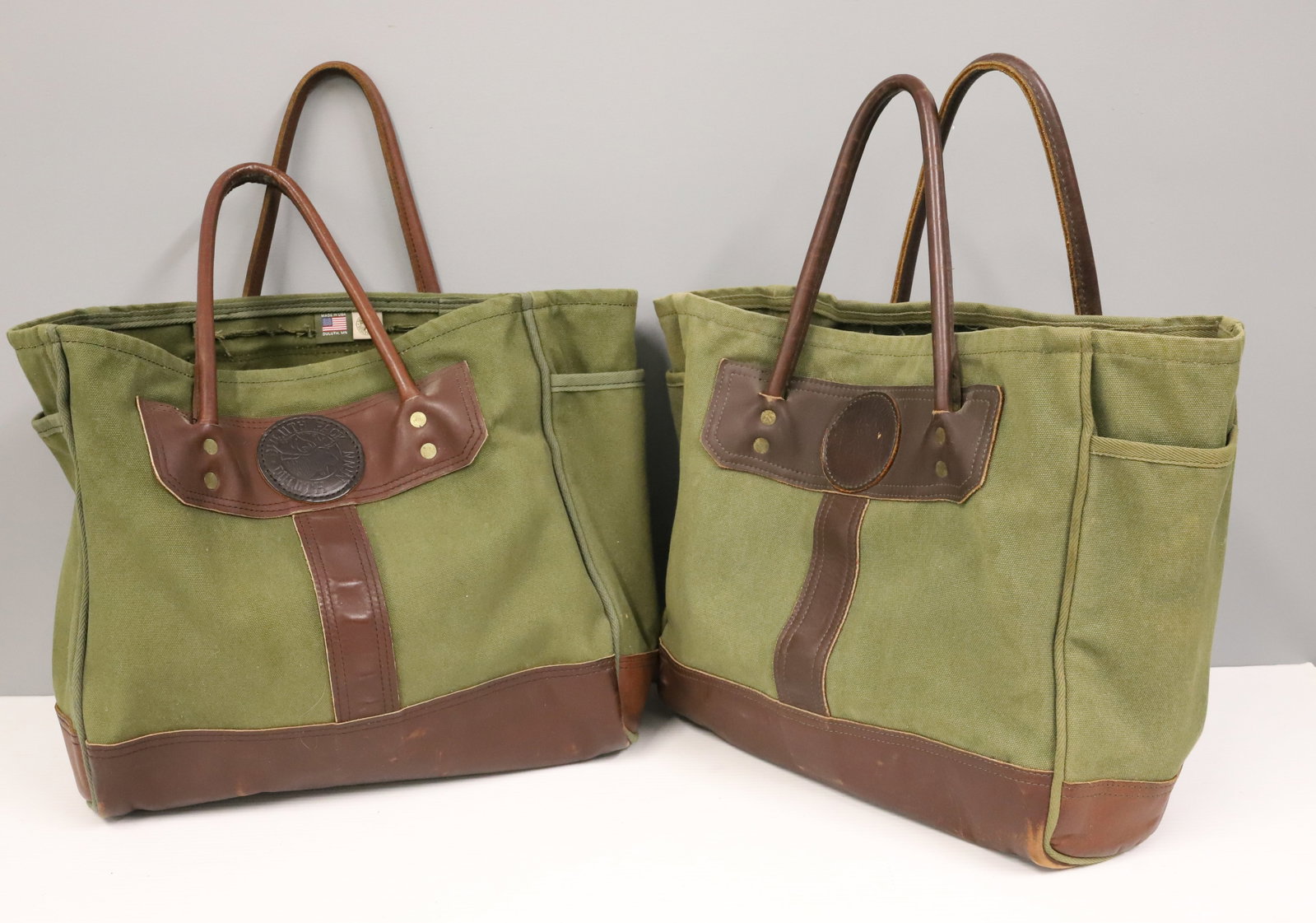 (2) DULUTH LEATHER / CANVAS BAGS: GREEN CANVAS WITH LEATHER TRIM AND HANDLES. 14" X 14". PLEASE READ CAREFULLY - ITEMS MUST BE PAID FOR THROUGH LIVE AUCTIONEERS OR WITH CASH OR CHECK IN PERSON - Terms for Purchasing and Shipping of
