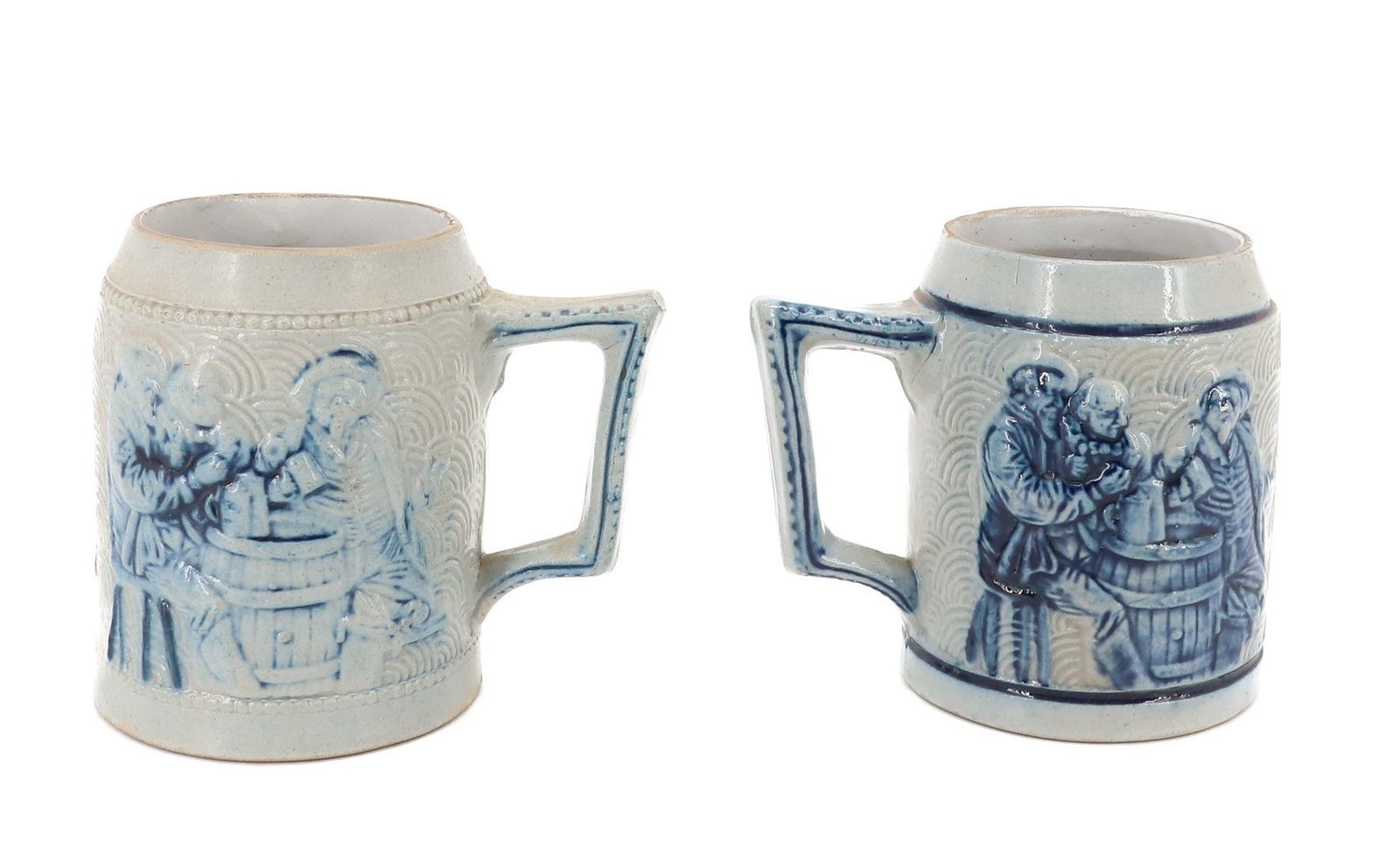 (2) WHITE'S UTICA STONEWARE MUGS: MOLDED BUFFALO AND THREE MEN DRINKING BEER AROUND A BARREL. 4 1/4" H. PLEASE READ CAREFULLY - ITEMS MUST BE PAID FOR THROUGH LIVE AUCTIONEERS OR WITH CASH OR CHECK IN PERSON - Terms for Purchasing