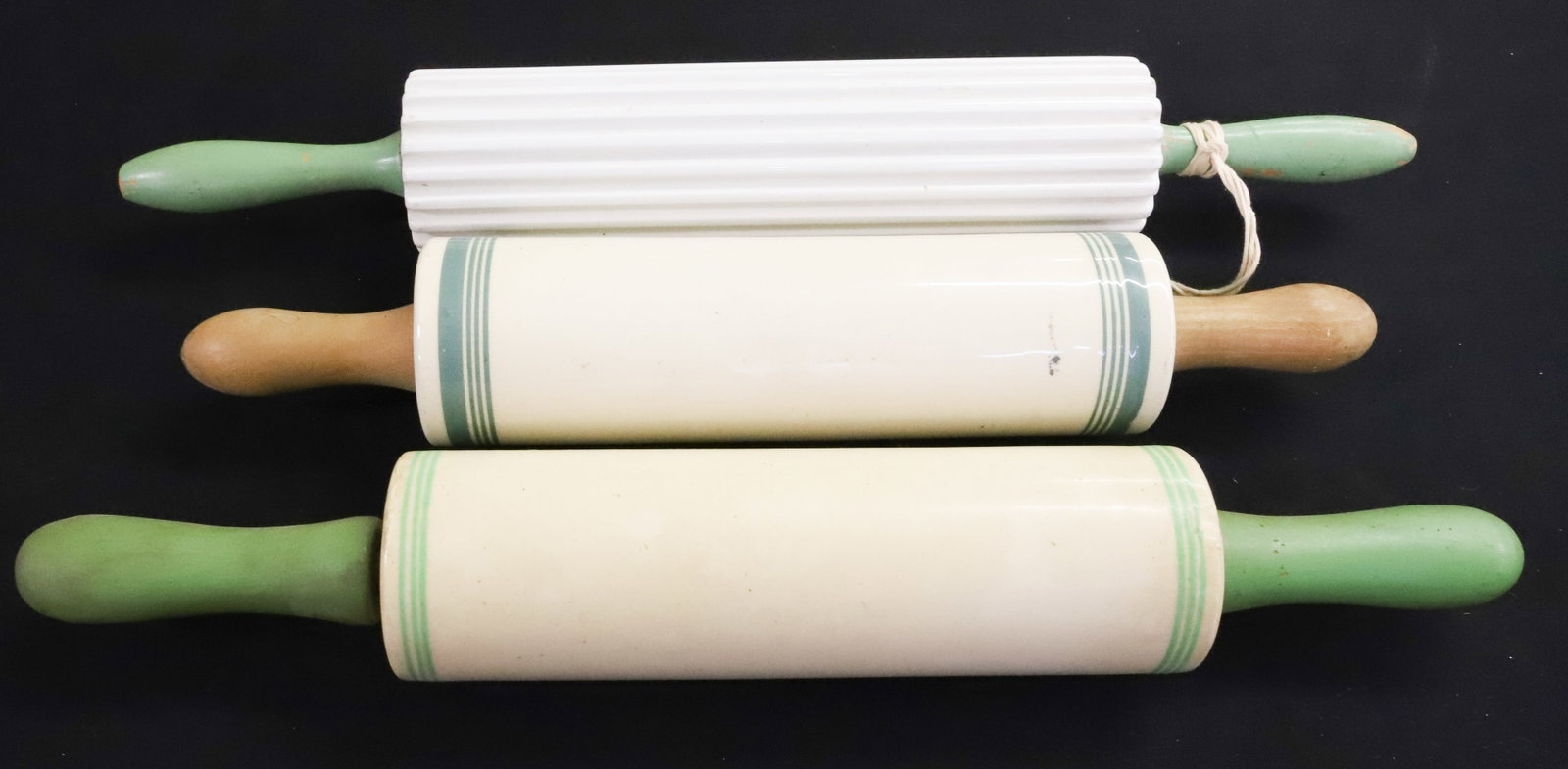 (3) CERAMIC / POTTERY ROLLINGS PINS: TWO HAVE GREEN PAINTED HANDLES. TWO HAVE GREEN BANDING (ONE MRKD. ENGLAND). ONE HAS RIBBED BODY. (PAT. NO. ON END). LARGEST 18" L. PLEASE READ CAREFULLY - ITEMS MUST BE PAID FOR THROUGH LIVE