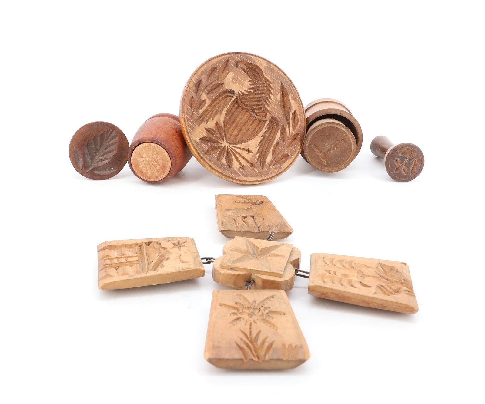 GROUP OF WOODEN BUTTER STAMPS / MOLDS: 1" TO 3 3/4" DIAMETERS. INCLUDING CARVED EAGLE, LEAF, FLOWER, LETTER "T" AND MORE. PLEASE READ CAREFULLY - ITEMS MUST BE PAID FOR THROUGH LIVE AUCTIONEERS OR WITH CASH OR CHECK IN PERSON - Terms for