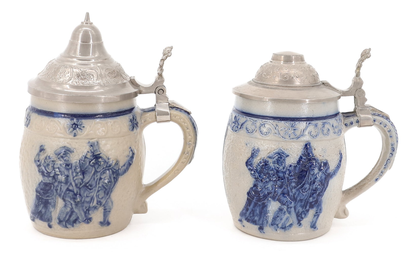 (2) WHITE'S UTICA STONEWARE STEINS: EMBOSSED STONEWARE WITH BLUE DECORATION. PEWTER LIDS. MRKD. 40 ON BOTTOM. 5 1/2" AND 6 3/4" HEIGHTS. PLEASE READ CAREFULLY - ITEMS MUST BE PAID FOR THROUGH LIVE AUCTIONEERS OR WITH CASH OR CHECK IN PE