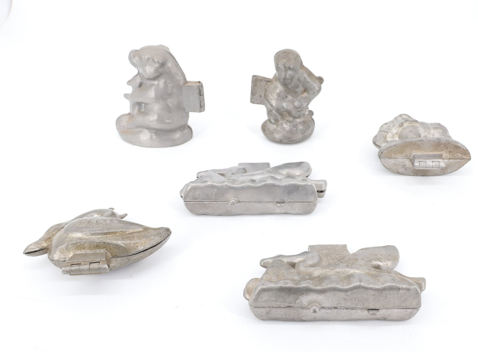 LOT OF (6) PEWTER ICE CREAM MOLDS, CHOCOLATE: INCLUDING: SWAN MRKD. CC 834. SITTING BEAR MRKD. 222 (4 1/8" H.) ELEPHANT MRKD. CC, FRANCE. GORILLA MRKD. E&CO. NY 532. (SMALL HOLE IN BOTTOM). (2) STORKS DELIVERING BABY MRKD. 631K. PLEASE READ CAREF