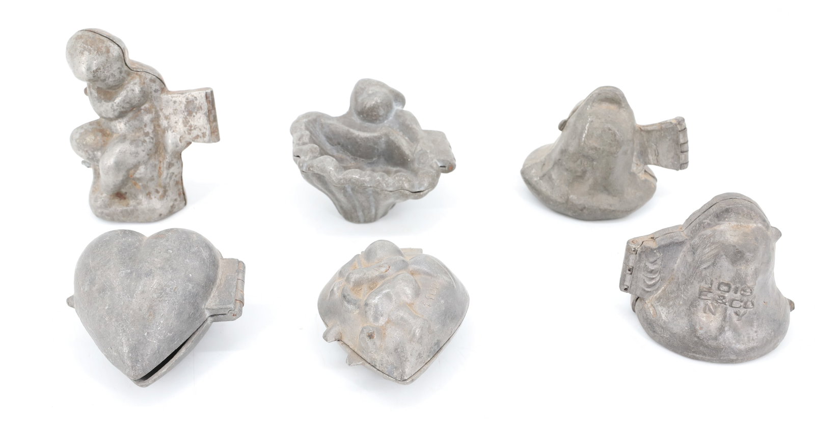 LOT OF (6) PEWTER ICE CREAM MOLDS, CHOCOLATE: INCLUDING: (2) CHERUB ON BELL (E&CO. NY). CUPID ON A HEART (E&CO. 1102) 3 1/2" L. HEART. SEATED CHERUB (E&CO. 992) 4 1/2" H. CHERUB W/ SHELL. PLEASE READ CAREFULLY - ITEMS MUST BE PAID FOR THROUGH LIV