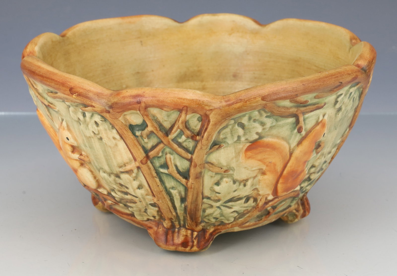WELLER POTTERY "WOODCRAFT" BOWL: SQUIRREL IN FOREST MOTIF. 3" X 6 1/2". PLEASE READ CAREFULLY - ITEMS MUST BE PAID FOR THROUGH LIVE AUCTIONEERS OR WITH CASH OR CHECK IN PERSON - Terms for Purchasing and Shipping of Auction Items.