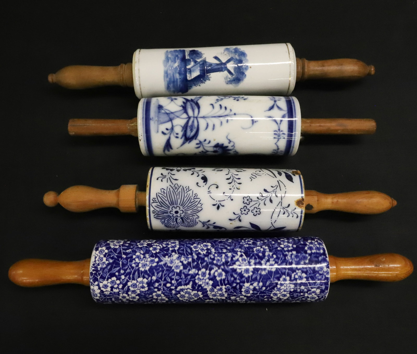 LOT OF STONEWARE / CERAMIC ROLLING PINS: INCLUDING: BLUE ONION PATTERN. CALICO/CHINTZ PATTERN (MRKD. ON END). EXAMPLE WITH WINDMILL MOTIF. LARGEST 16 1/2" L. PLEASE READ CAREFULLY - ITEMS MUST BE PAID FOR THROUGH LIVE AUCTIONEERS OR WITH