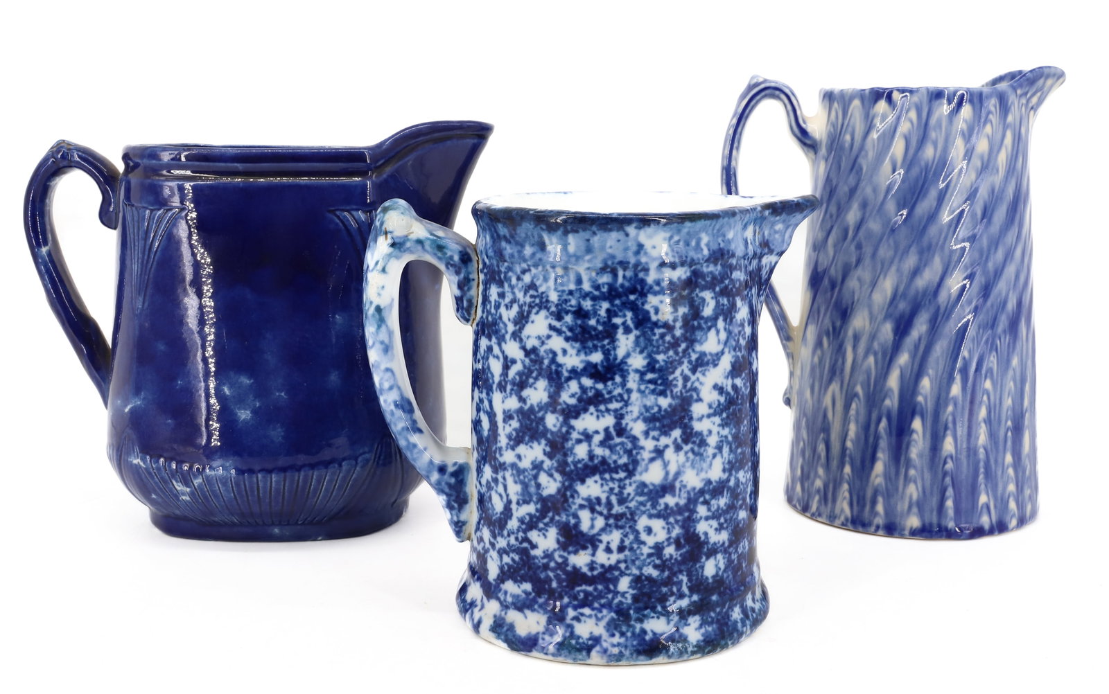 (3) BLUE / WHITE SPONGEWARE PITCHERS: VARIETY OF SIZES AND SPONGING. 6 1/2" TO 8 1/2" HEIGHTS. TALLEST MRKD. MOORLAND, ENGLAND. PLEASE READ CAREFULLY - ITEMS MUST BE PAID FOR THROUGH LIVE AUCTIONEERS OR WITH CASH OR CHECK IN PERSON - Term
