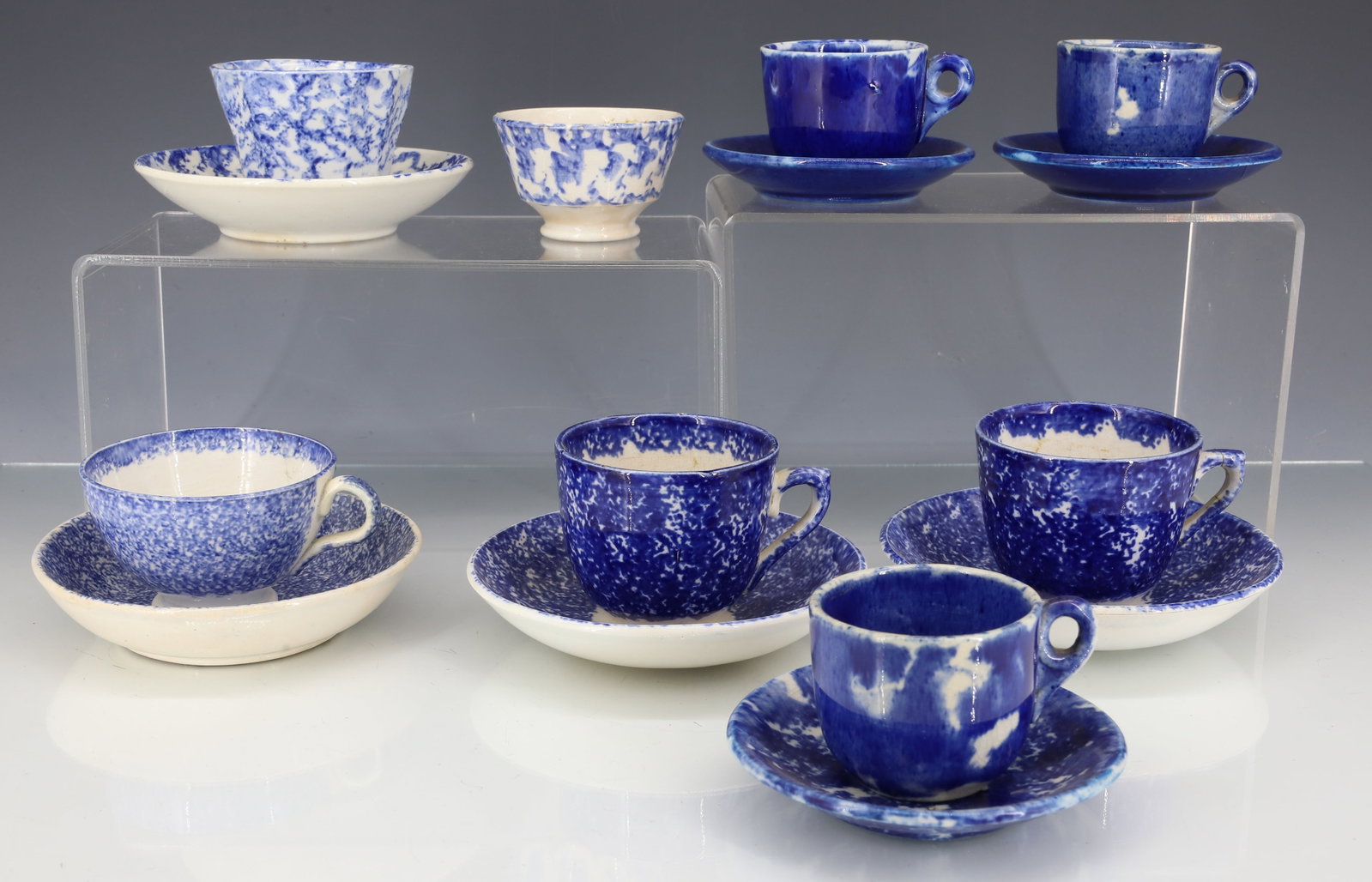 LOT OF MINIATURE SPONGEWARE CUPS / SAUCERS: VARIETY OF SIZES AND SPONGING. (8) CUPS AND (7) SAUCERS. LARGEST IS 2" X 2 1/2" WITH 4 3/8" SAUCER. PLEASE READ CAREFULLY - ITEMS MUST BE PAID FOR THROUGH LIVE AUCTIONEERS OR WITH CASH OR CHECK IN PER