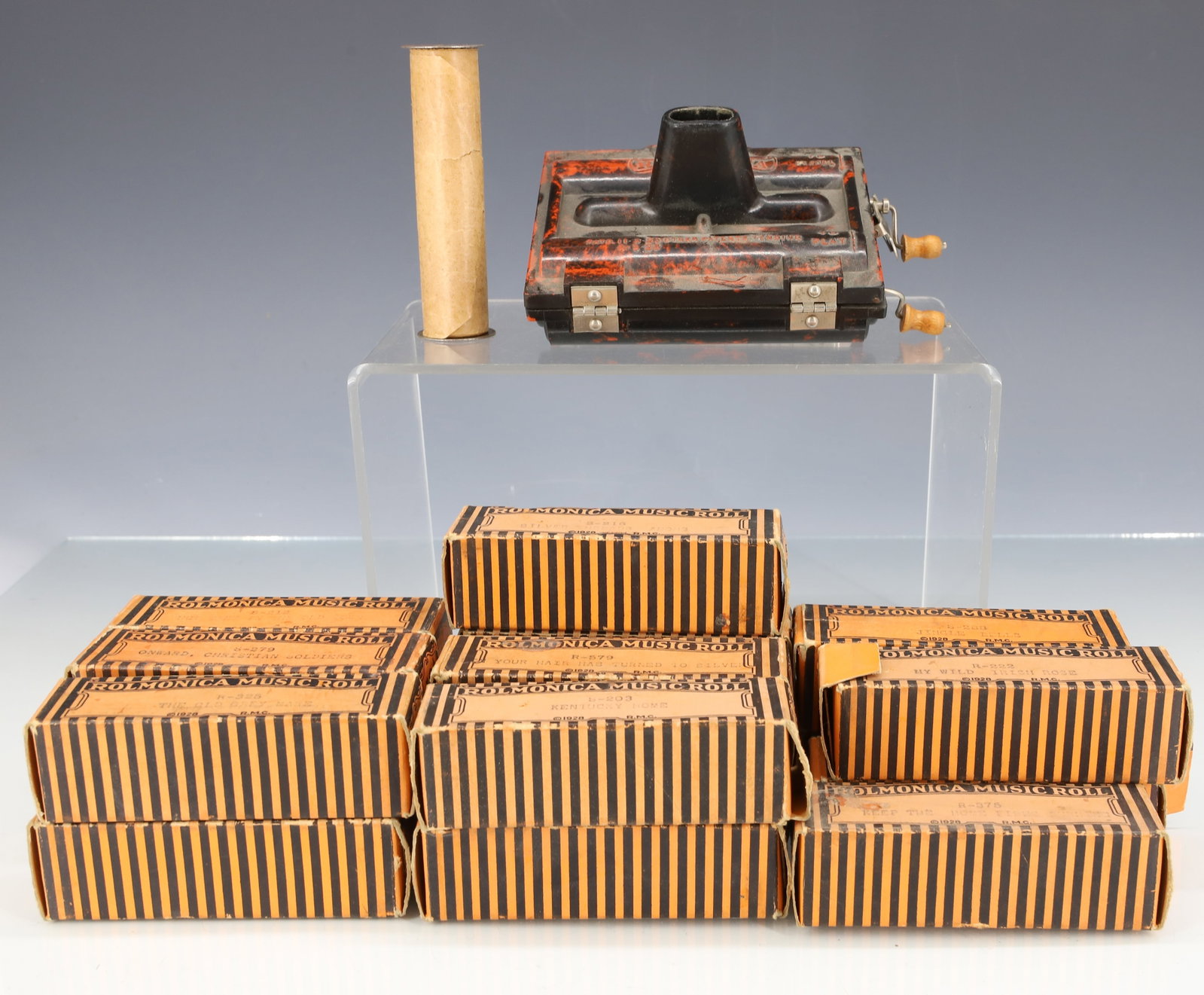 VINTAGE ROLMONICA WITH MUSIC ROLLS: MOLDED "ROLMONICA" PAT. 1928(4" X 3 1/2") WITH 18 BOXED ROLLS. PLEASE READ CAREFULLY - ITEMS MUST BE PAID FOR THROUGH LIVE AUCTIONEERS OR WITH CASH OR CHECK IN PERSON - Terms for Purchasing and