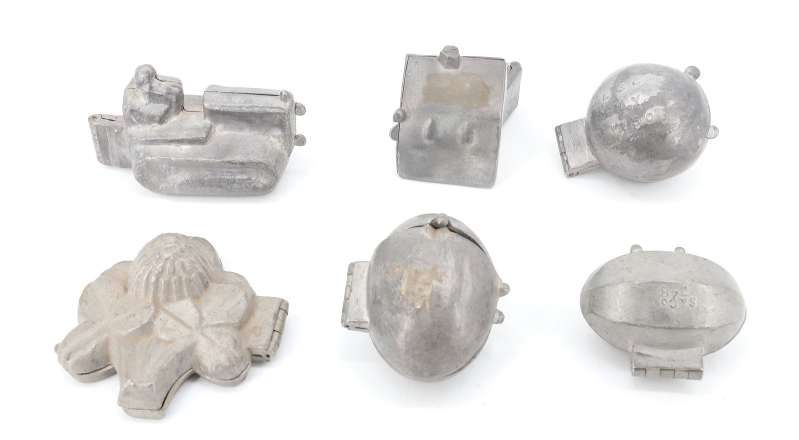 LOT OF (6) PEWTER ICE CREAM MOLDS, CHOCOLATE: INCLUDING: FOOTBALL (381). BASKETBALL (E&CO. NY 1150). HOUSE MRKD. 637K (2 3/4" X 2 1/4"). EIGHT-SIDE OVAL (MELON?) MRKD. S&CO. 248. FLOWER W/ LEAVES (560). TRACTOR (UNMARKED). PLEASE READ CAREFULLY -