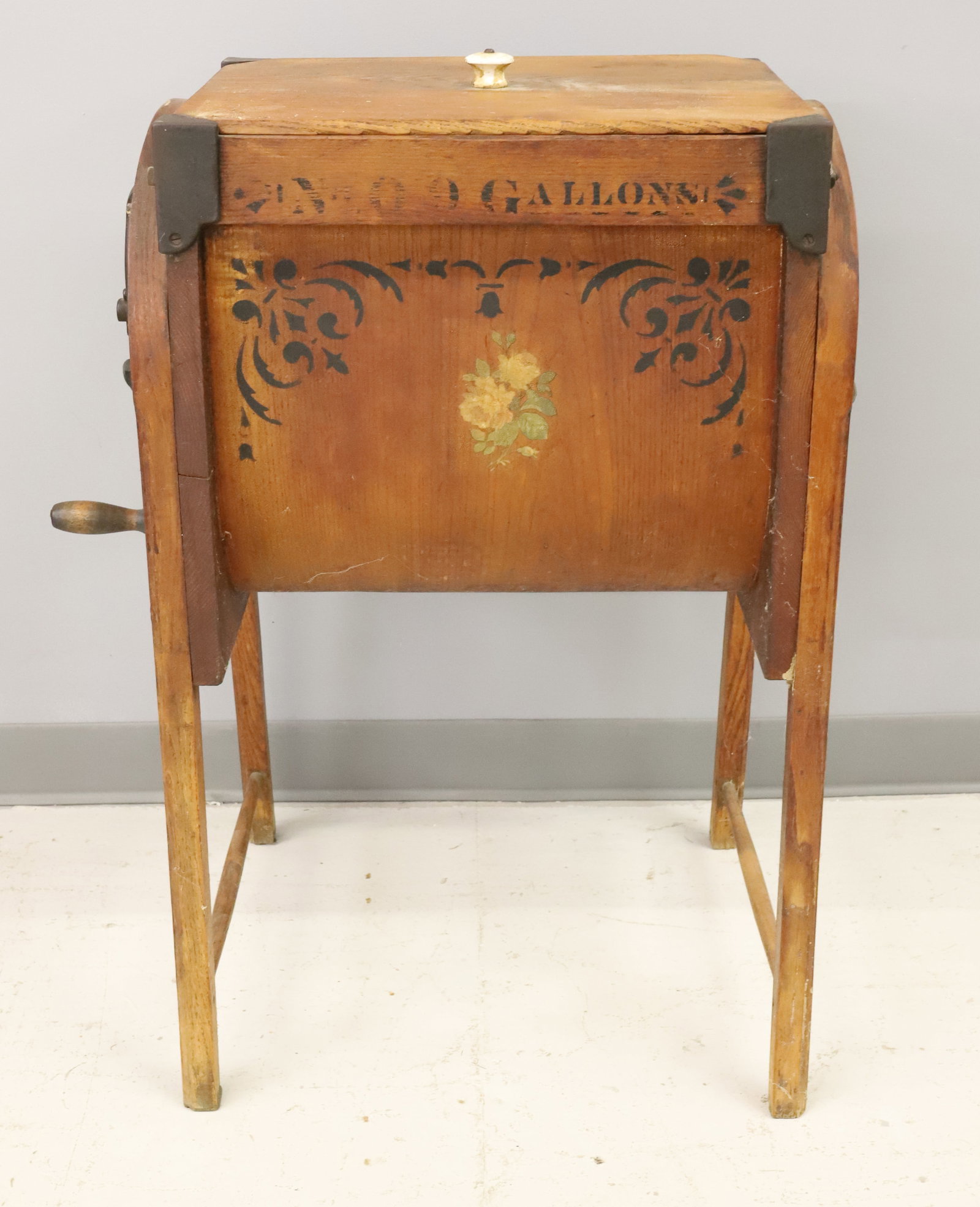 "THE BENTWOOD" BUTTER CHURN: WOODEN CONSTRUCTION WITH IRON. STENCILED ON END "THE BENT WOOD CHURN, MANUFD BY M. BROWN & CO. WAPAKONOTA, O." ON SIDES "NO. 0, 9 GALLONS" WITH FLORAL DECORATION. 32" X 21" X 15". PLEASE READ CAREFULL