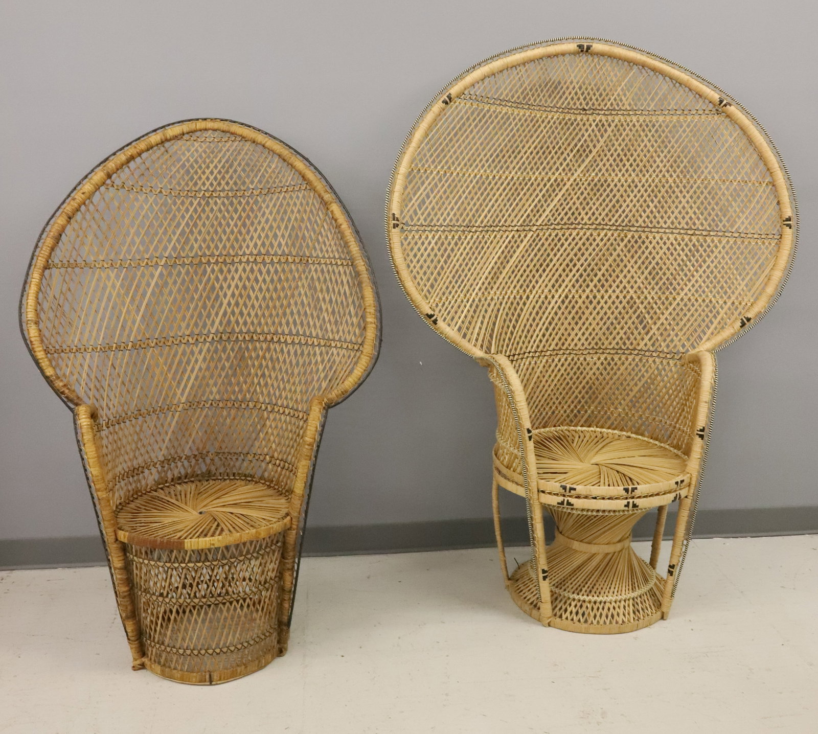 (2) VINTAGE WOVEN PEACOCK CHAIRS: WOVEN CONSTRUCTION WITH BLACK HIGHLIGHTED DECORATION. 59 1/2" X 44" X 20" AND 51" X 34" X 17 1/2". PLEASE READ CAREFULLY - ITEMS MUST BE PAID FOR THROUGH LIVE AUCTIONEERS OR WITH CASH OR CHECK IN