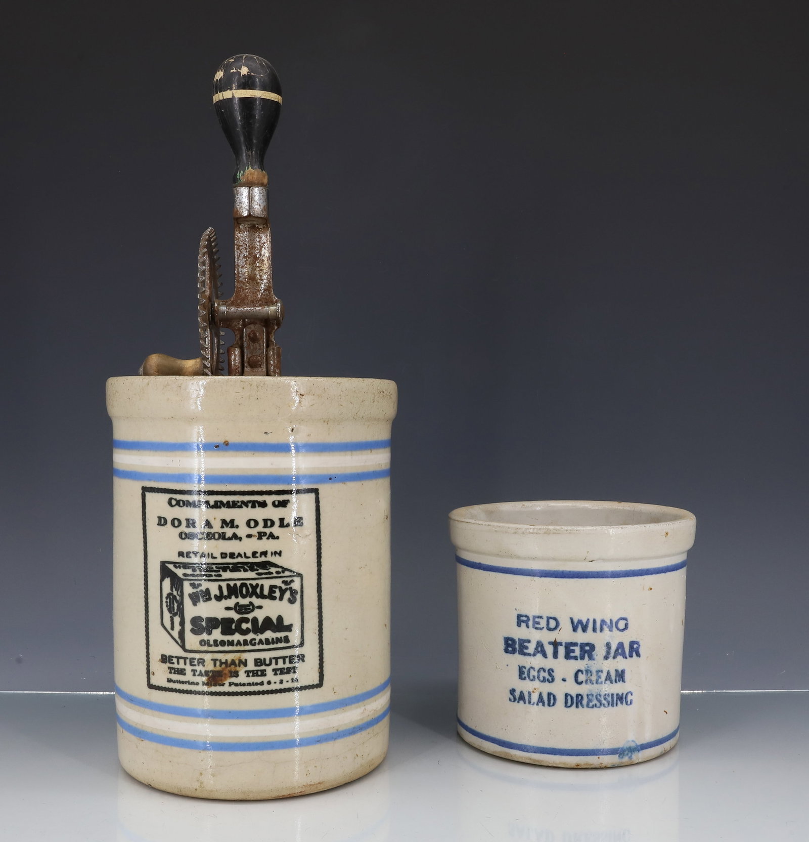 (2) ADVERTISING BEATER JARS: INCLUDING: RED WING BEATER JAR..EGGS..CREAM..SALAD DRESSING 4 7/8" X 5 1/4". WITH, JAR W/ BEATER "COMPLIMENTS OF DORAM ODLE, OSCEOLA, PA...RETAIL DEALER IN "WM. J. MOXLEY'S SPECIAL OLEOMARGARINE" JAR