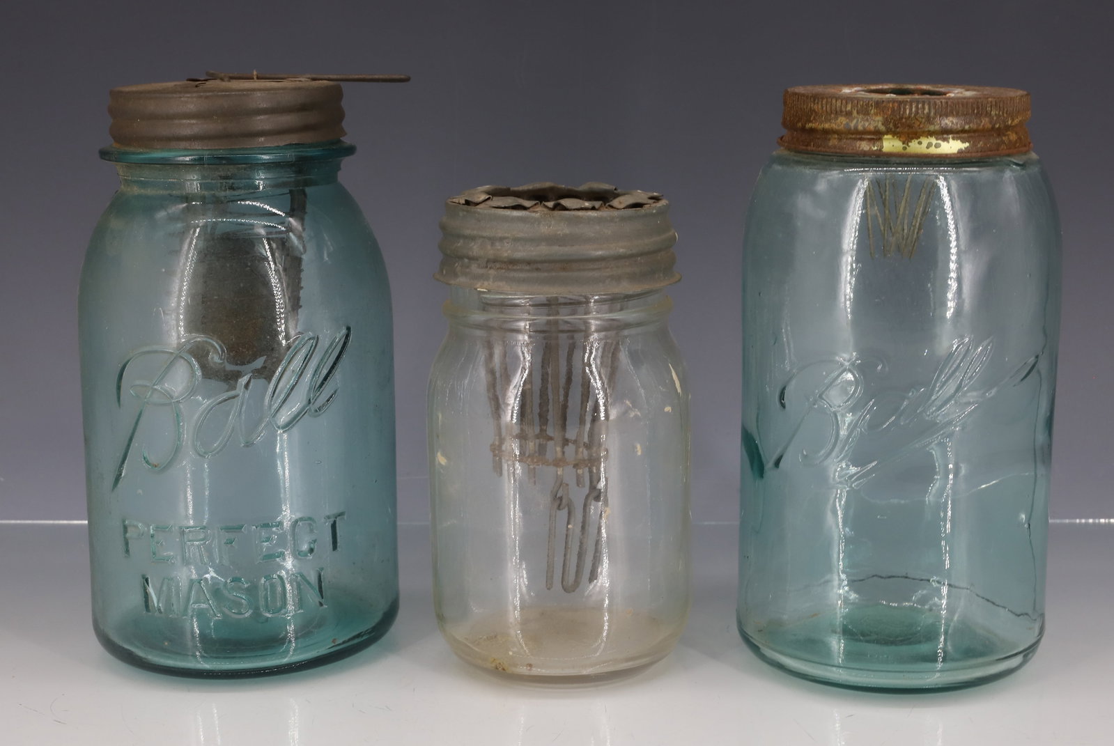 (3) VINTAGE JAR MOUSETRAPS: METAL LIDS WITH MOUSETRAPPING MECHANISMS. 5 1/2" TO 7 1/4" H. PLEASE READ CAREFULLY - ITEMS MUST BE PAID FOR THROUGH LIVE AUCTIONEERS OR WITH CASH OR CHECK IN PERSON - Terms for Purchasing and