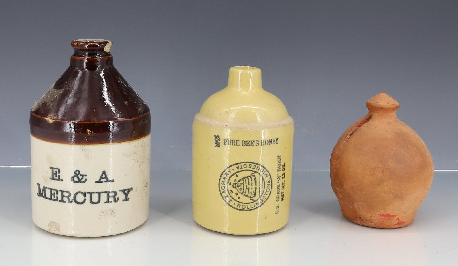 STONEWARE ADVERTISING JUGS AND BANK (1 of 5)