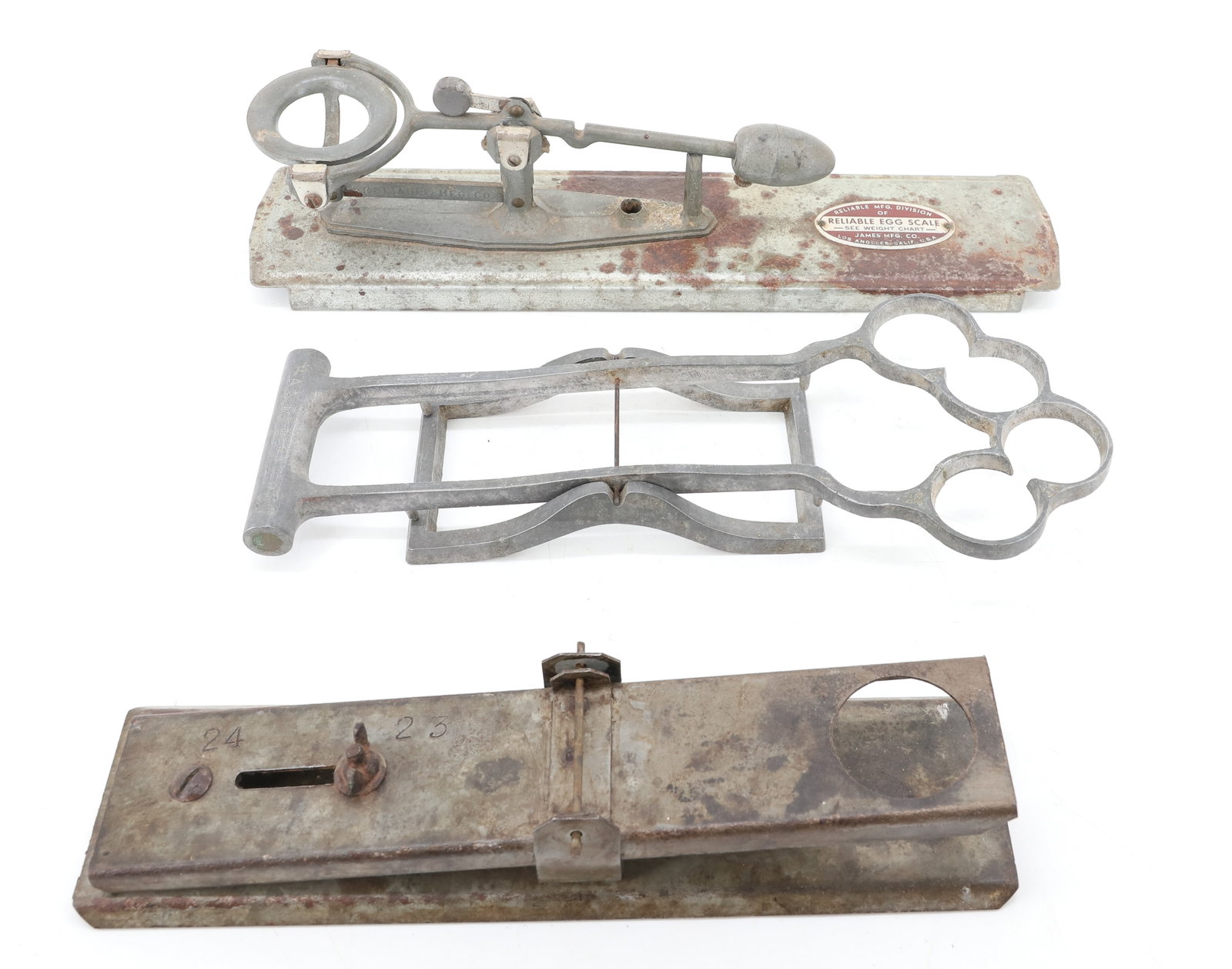 (3) VINTAGE EGG SCALES: INCLUDING: RELIABLE EGG SCALE (LOS ANGELES). 12 3/4" L. "HANDEE" ALUMINUM TWO-PIECE SCALE 11 1/4" L. UNMARKED SCALE WITH 24/25. PLEASE READ CAREFULLY - ITEMS MUST BE PAID FOR THROUGH LIVE AUCTIONEERS