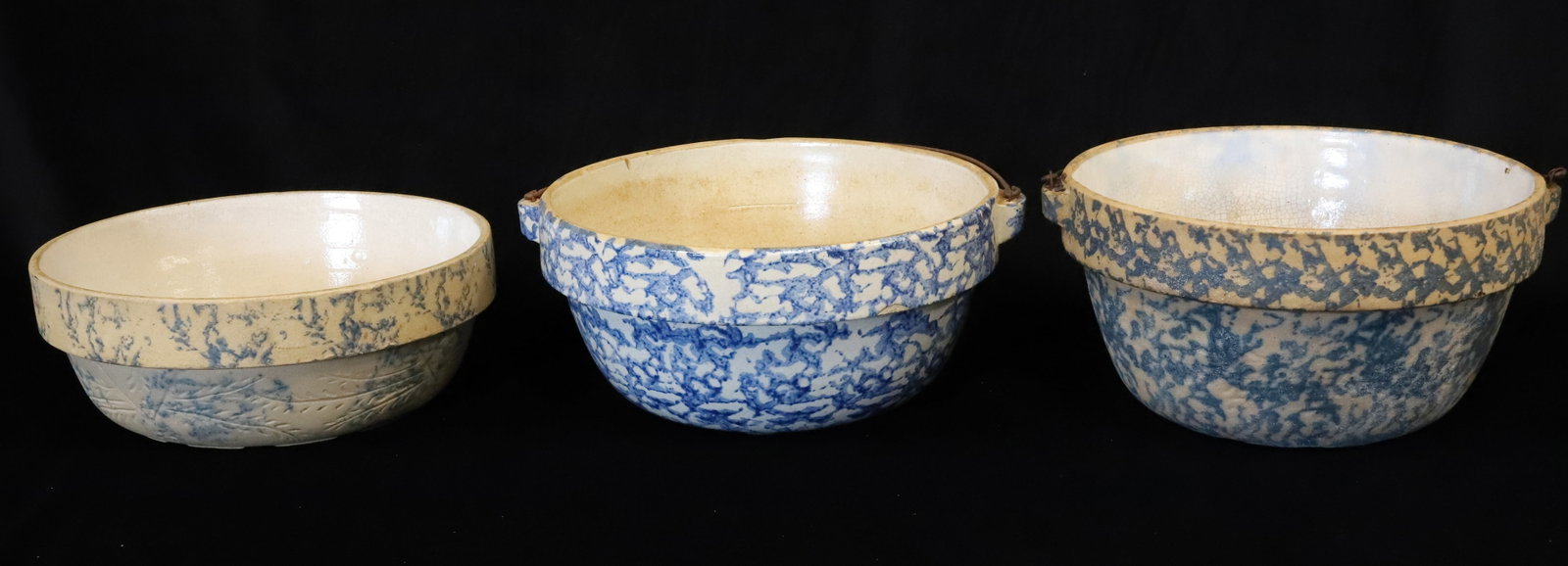 (3) BLUE SPONGEWARE BOWLS: INCLUDING: LOW BOWL WITH INCISED DECORATION. MRKD. THE PURE FOOD SANITARY COOKING WARE (ON BOTTOM). 10" D. TWO BAIL HANDLED BOWLS. 4 7/8" X 10" AND 5" X 10". PLEASE READ CAREFULLY - ITEMS MUST BE