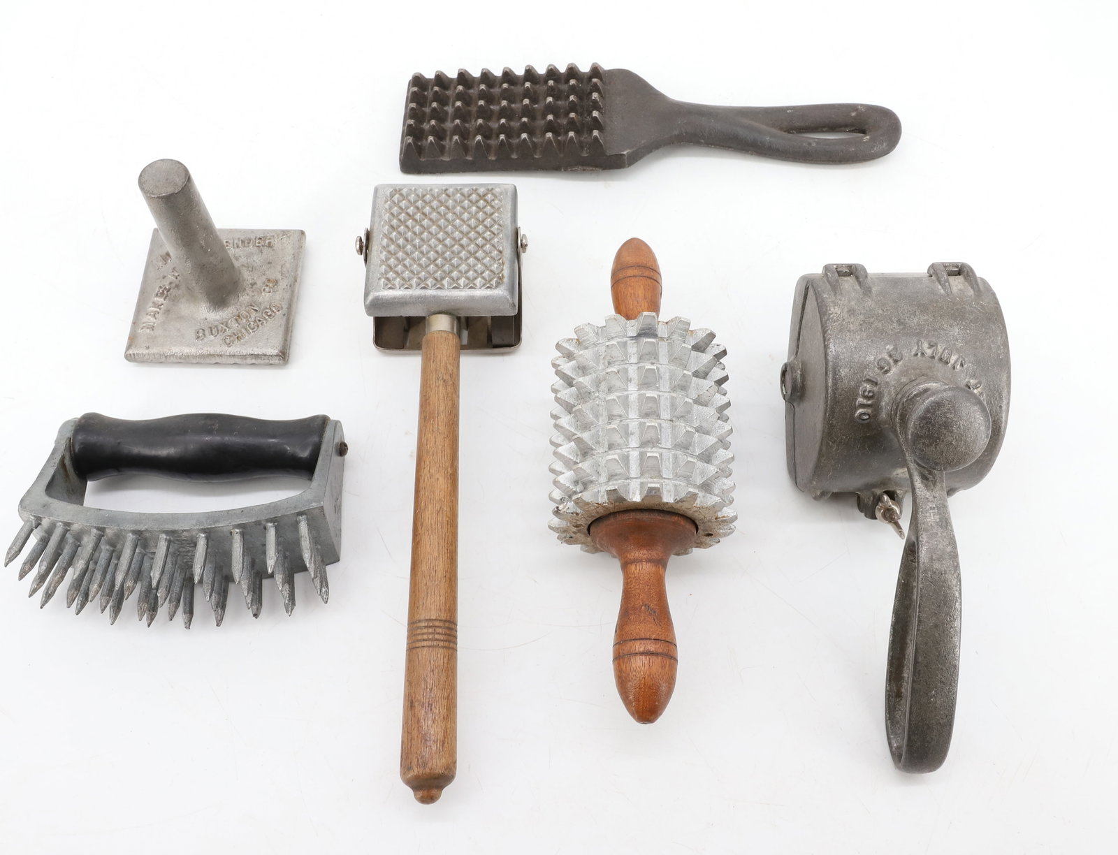(6) ANTIQUE MEAT TENDERIZERS / CHOPPERS: VARIOUS FORMS AND MATERIALS. INCLUDING: WOODEN HANDLED TENDERIZER/CUTTER. ROLLING PIN FORM 8" L. CAST IRON EXAMPLE. SQUARE EXAMPLE MRKD. "MI-PET MAKES MEAT TENDER, BUXTON CO. CHICAGO". SPIKED