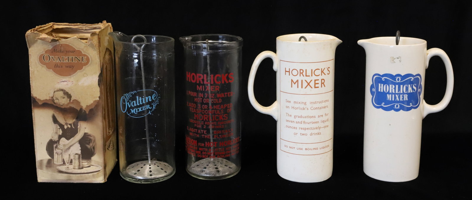 LOT OF HORLICK'S / OVALTINE MIXERS: (3) HORLICK'S MIXERS INCLUDING: GLASS W/ RED LETTERING (MADE IN ENGLAND) WITH TWO POTTERY PITCHERS W/ HANDLES AND PLUNGERS. (ENGLAND). PLUS, OVALTINE MIXER IN ORIGINAL BOX. 8 1/4" H. PLEASE READ