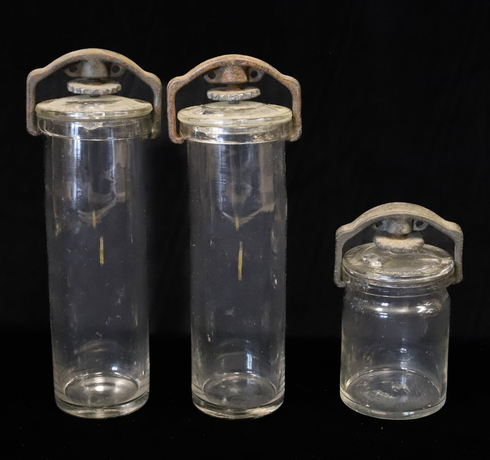 (3) WHITALL, TATUM & CO. GLASS STORAGE JARS: EMBOSSED LIDS MRKD. "WHITALL, TATUM & CO. PHILADELPHIA, NEW YORK, PAT. JUNE 11TH 1895". TWIST KNOB / IRON CLOSURES. TWO ARE 8" H. AND ONE 4" H. PLEASE READ CAREFULLY - ITEMS MUST BE PAID FOR THROUGH