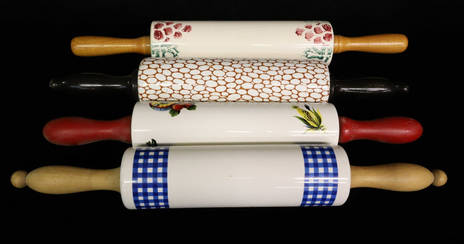 (4) CERAMIC DECORATED ROLLING PINS: BLUE/WHITE CHECK. MEXICAN THEME. BROWN PEBBLE PATTERN. STENCIL FRUIT PATTERN. ALL HAVE WOODEN INSERT HANDLES. LONGEST 18 1/4". PLEASE READ CAREFULLY - ITEMS MUST BE PAID FOR THROUGH LIVE AUCTIONEERS