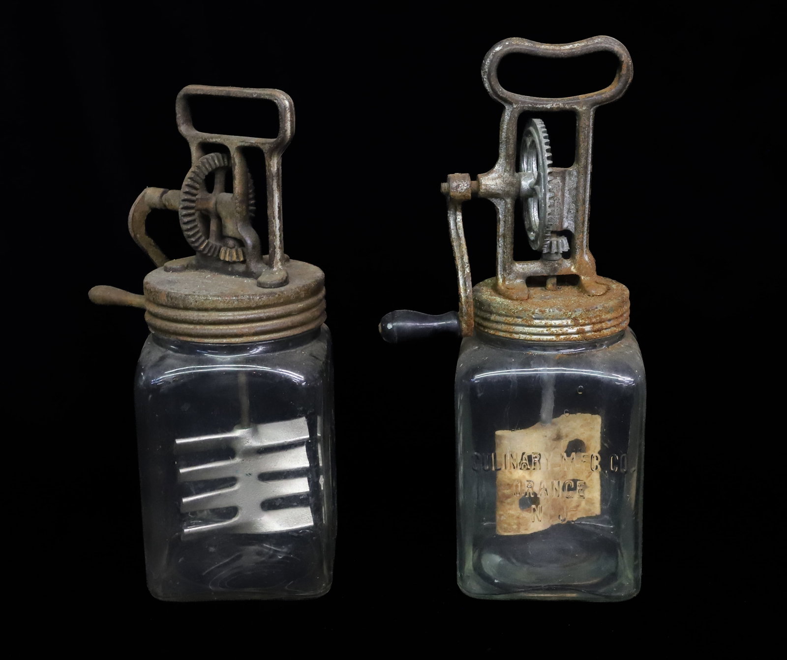 (2) GLASS BUTTER CHURNS: 2 QT. SIZE. ONE MRKD. "CULINARY MFG. CO., ORANGE, N.J." CAST IRON / METAL TOPS AND CRANKS. 12 3/4" AND 14 1/4" HEIGHTS. PLEASE READ CAREFULLY - ITEMS MUST BE PAID FOR THROUGH LIVE AUCTIONEERS OR WITH